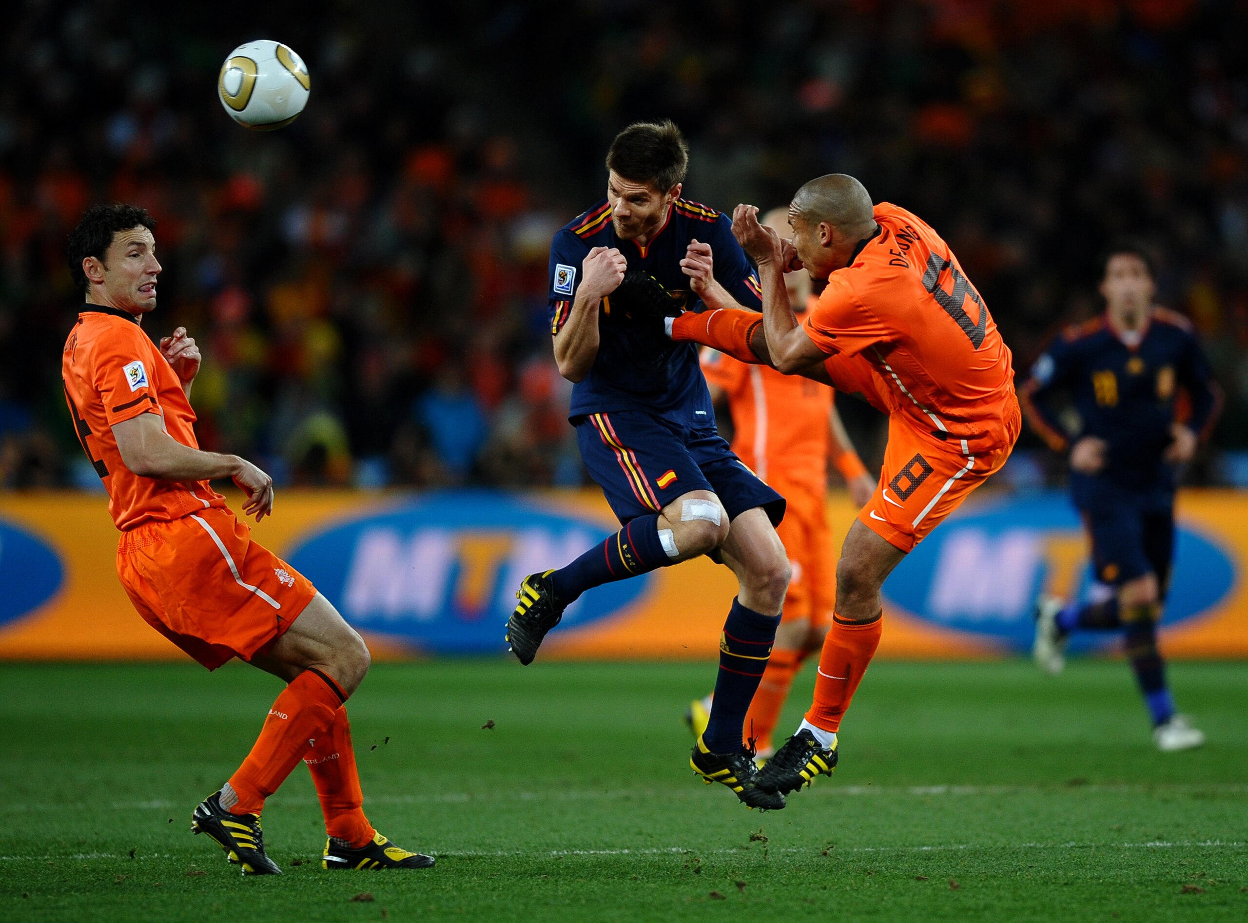 JOHANNESBURG, SOUTH AFRICA - JULY 11:  Nigel De Jong of the Netherlands tackles Xabi Alonso of Spain during the 2010 FIFA World Cup South Africa Final match between Netherlands and Spain at Soccer City Stadium on July 11, 2010 in Johannesburg, South Afric