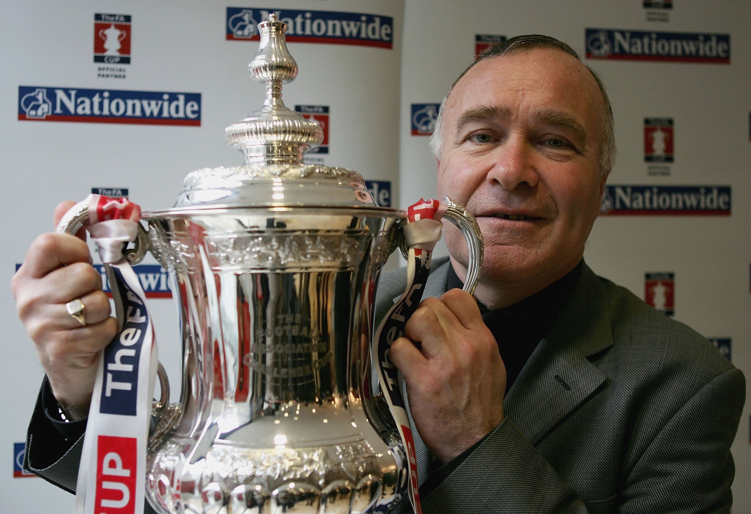 LONDON - FEBRUARY 15:  Former Chelsea player Ron Harris poses with the FA Cup ahead of this weekend's fourth round of the FA Cup at a Nationwide branch on February 15, 2006 in London, England.  (Photo by Paul Gilham/Getty Images)