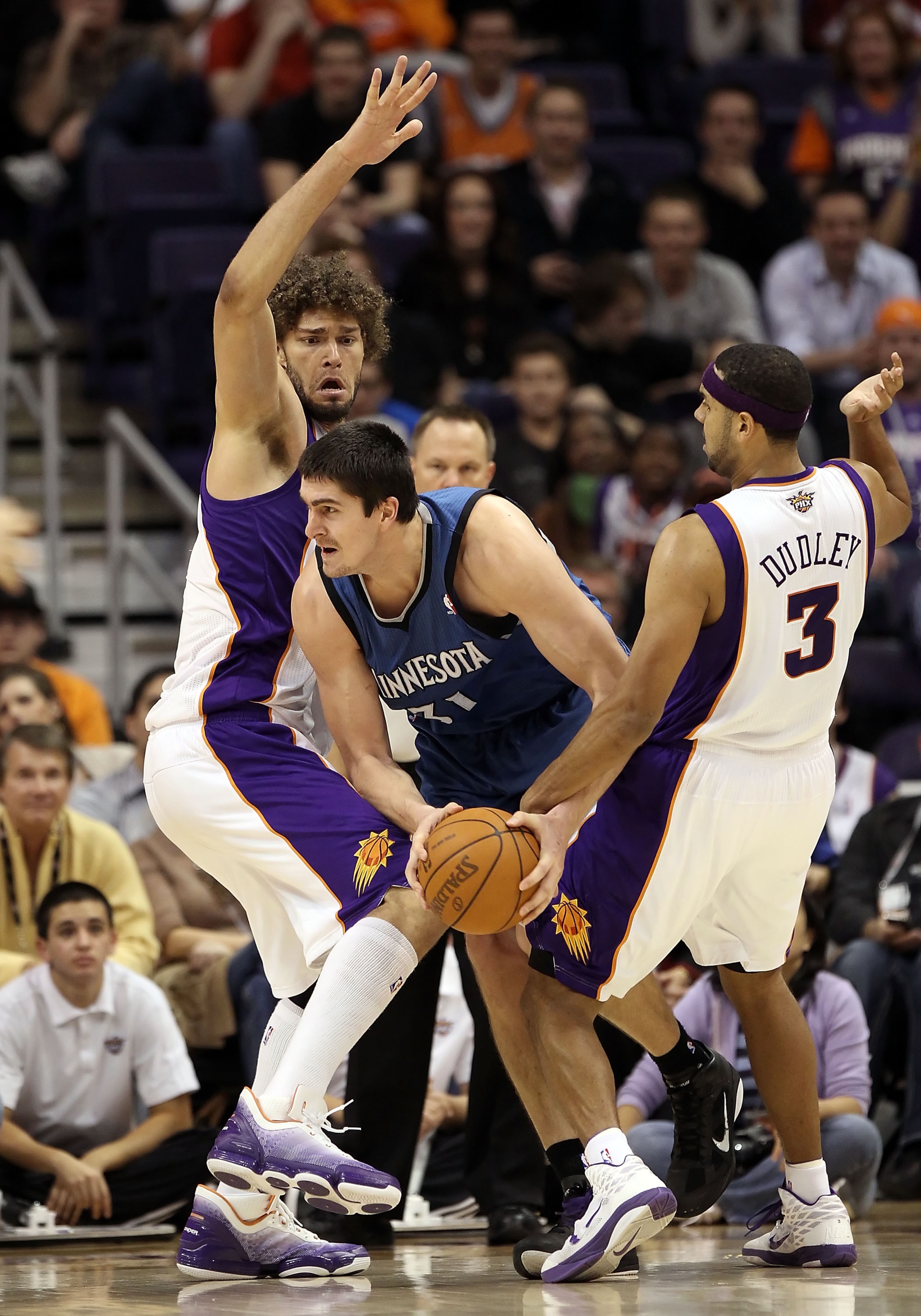 PHOENIX - DECEMBER 15:  Darko Milicic #31 of the Minnesota Timberwolves attempts to pass the ball against Robin Lopez of the Phoenix Suns during the NBA game at US Airways Center on December 15, 2010 in Phoenix, Arizona. NOTE TO USER: User expressly ackno