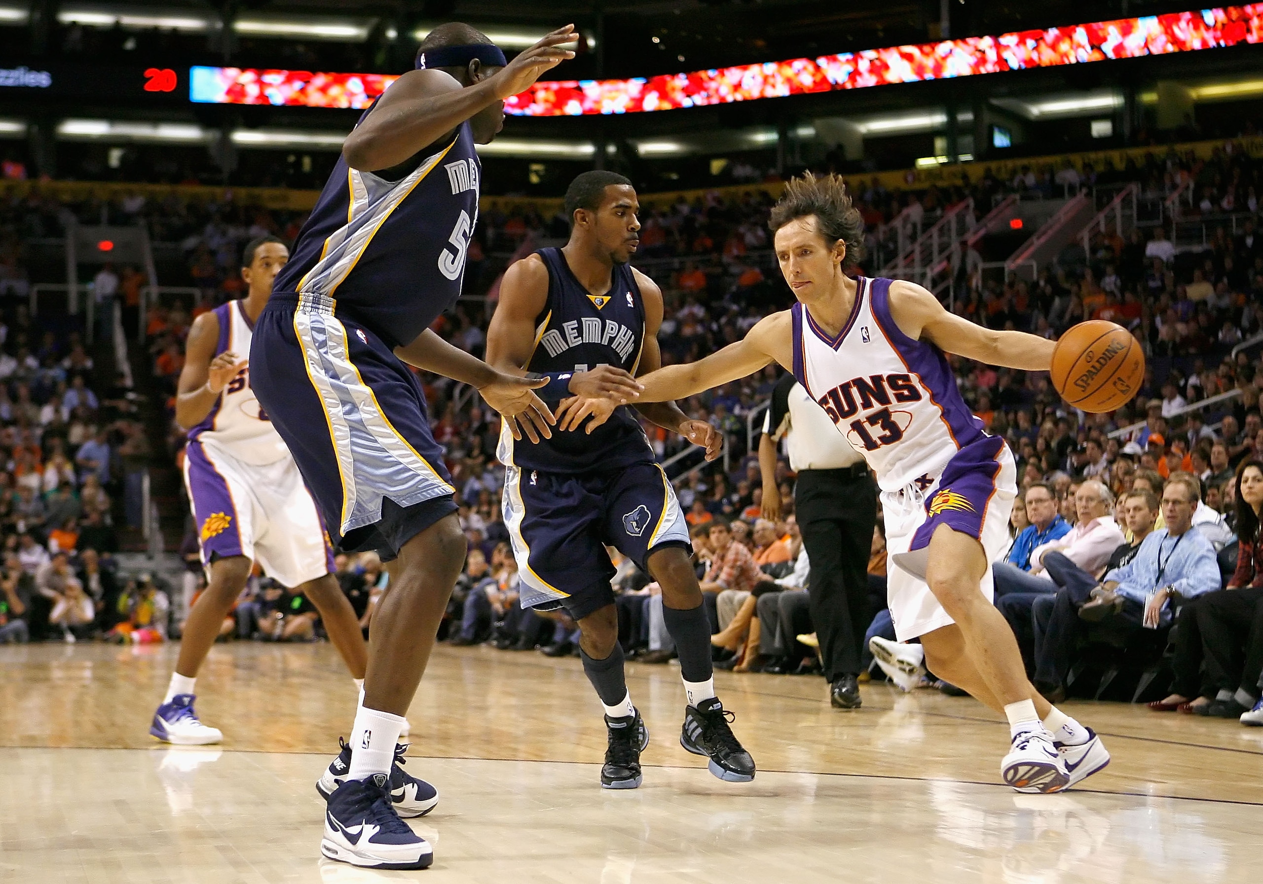 PHOENIX - NOVEMBER 25:  Steve Nash #13 of the Phoenix Suns handles the ball under pressure from Mike Conley #11 and Zach Randolph #50 of the Memphis Grizzlies during the NBA game at US Airways Center on November 25, 2009 in Phoenix, Arizona.  The Suns def