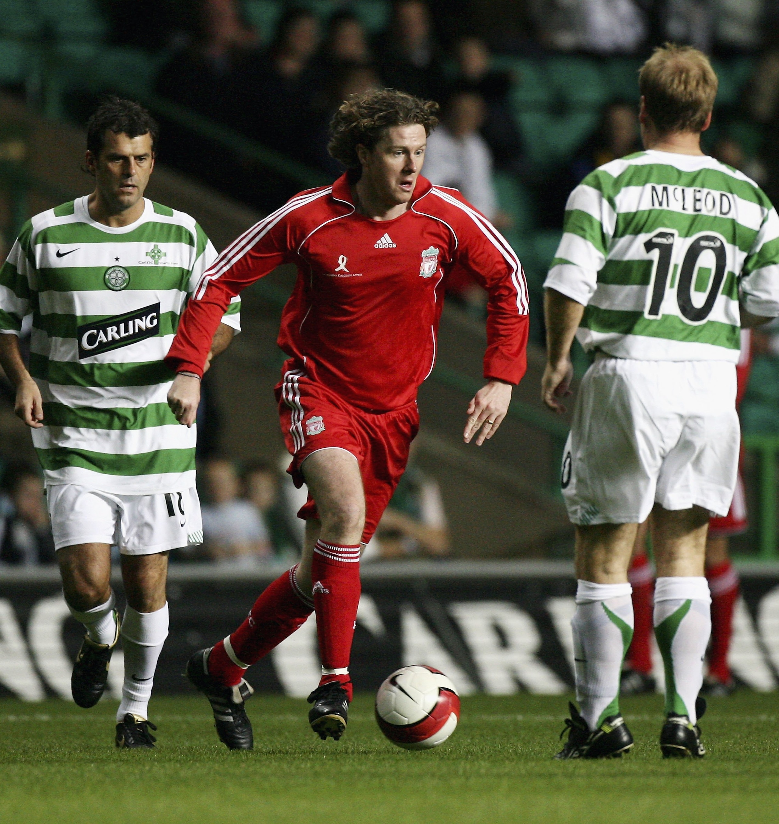 GLASGOW, UNITED KINGDOM - OCTOBER 04: Darren Jackson and Murdo MacLeod (R) of Celtic Legends attempt to stop Steven McManaman of Liverpool Legends during the charity chalenge match at Celtic Park on October 4, 2006 in Glasgow, Scotland.  (Photo by Jeff J