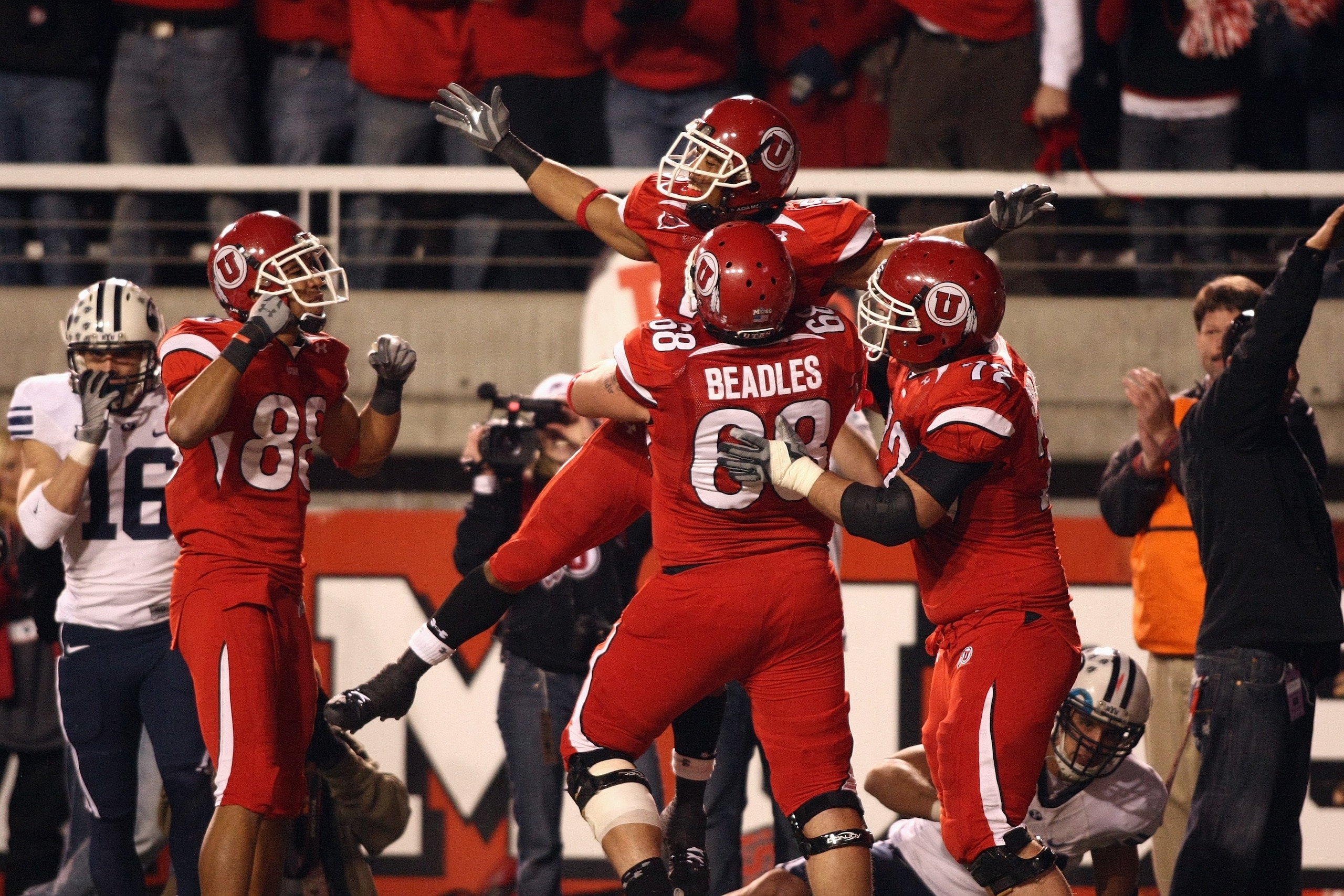 SALT LAKE CITY, UT - NOVEMBER 22:  Brent Casteel #5  of the Utah Utes celebrates with teammates Freddie Brown #88, Zane Beadles #68 and Caleb Schlauderaff #72 during the game against the BYU Cougars at Rice-Eccles Stadium on November 22, 2008 in Salt Lake