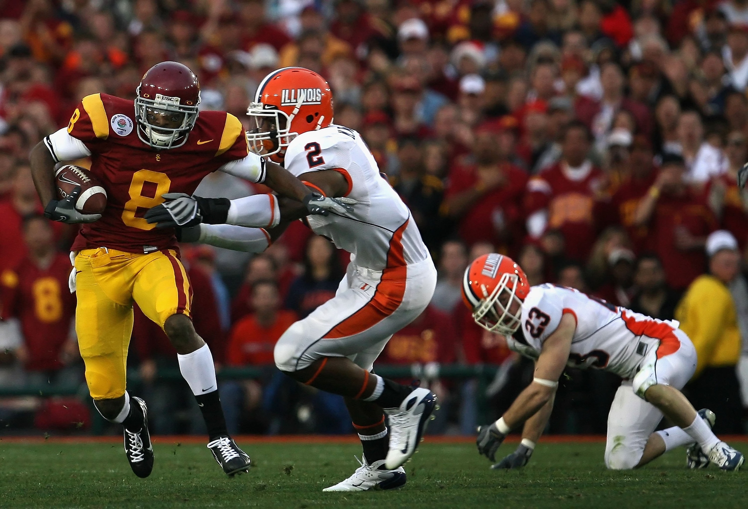 PASADENA, CA - JANUARY 01:  Wide receiver Ronald Johnson #8 of the USC Trojans returns a kick off for 14 yards under pressure from Martez Wilson #2 of the Illinois Fighting Illini during the Rose Bowl presented by Citi at the Rose Bowl on January 1, 2008 