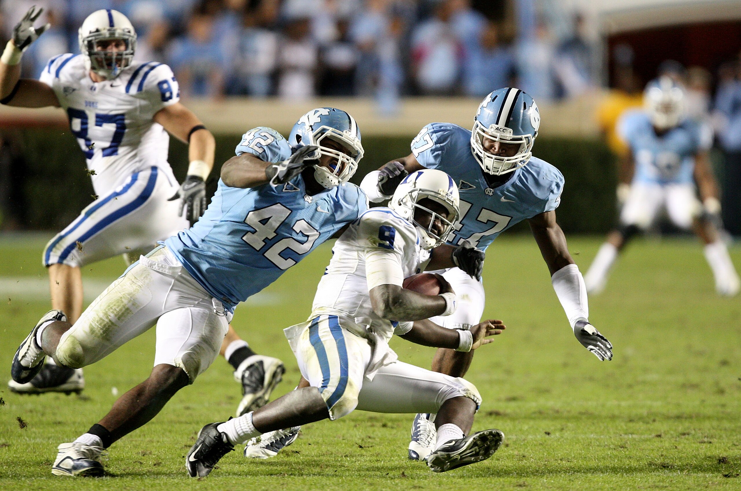 CHAPEL HILL, NC - NOVEMBER 07:  Thaddeus Lewis #9 of the Duke Blue Devils is sacked by Robert Quinn #42 of the North Carolina Tar Heels during their game at Kenan Stadium on November 7, 2009 in Chapel Hill, North Carolina.  (Photo by Streeter Lecka/Getty 