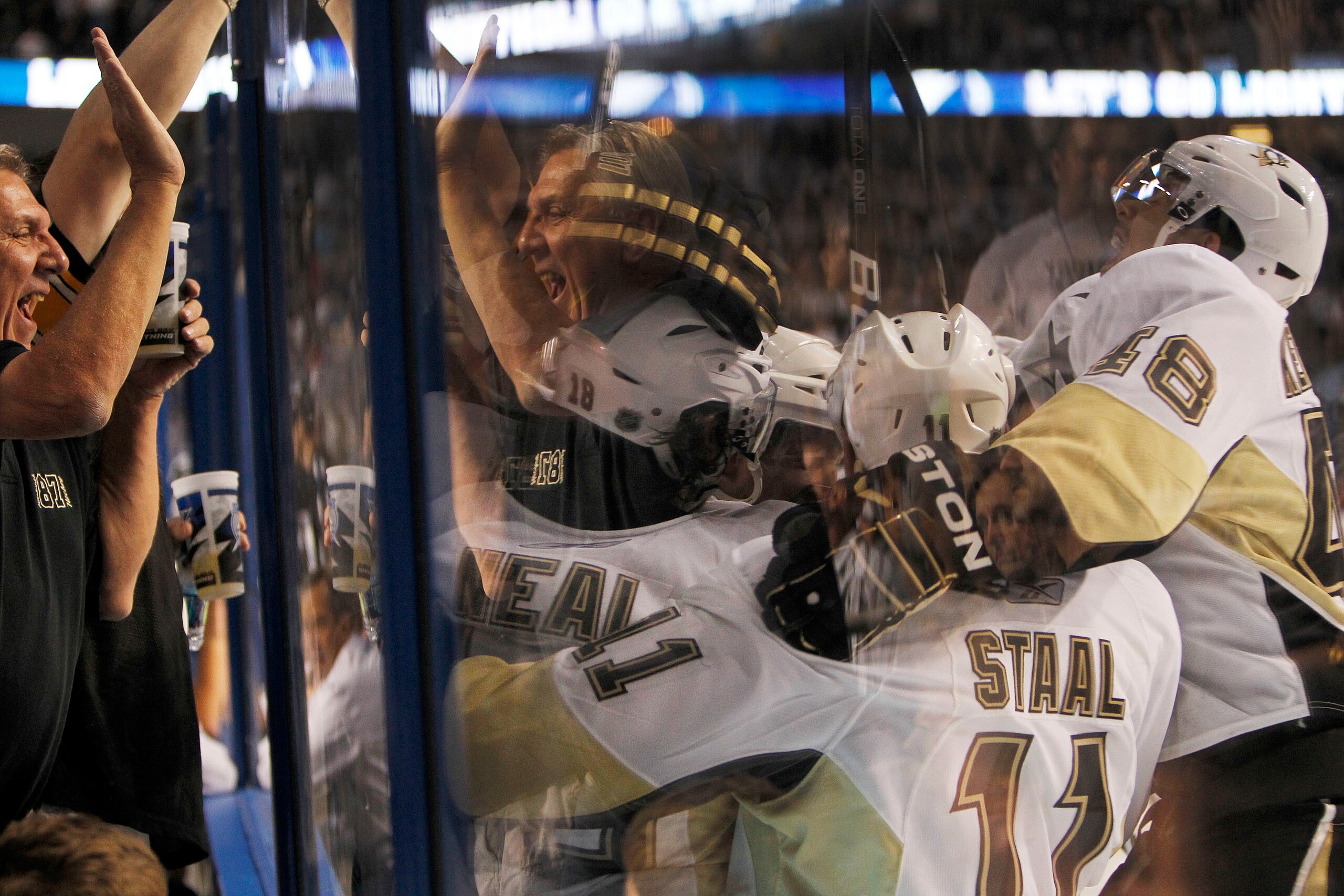 TAMPA, FL - APRIL 20: James Neal #18 of the Pittsburgh Penguins is swarmed by teammates after scoring the game winning goal in the second overtime period against the Tampa Bay Lightning in Game Four of the Eastern Conference Quarterfinals during the 2011