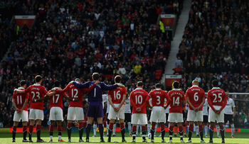 MANCHESTER, ENGLAND - MARCH 19:  The Manchester United players pay their respects to those who lost their lives in the Japan Earthquake disaster during the Barclays Premier League match between Manchester United and Bolton Wanderers at Old Trafford on Mar