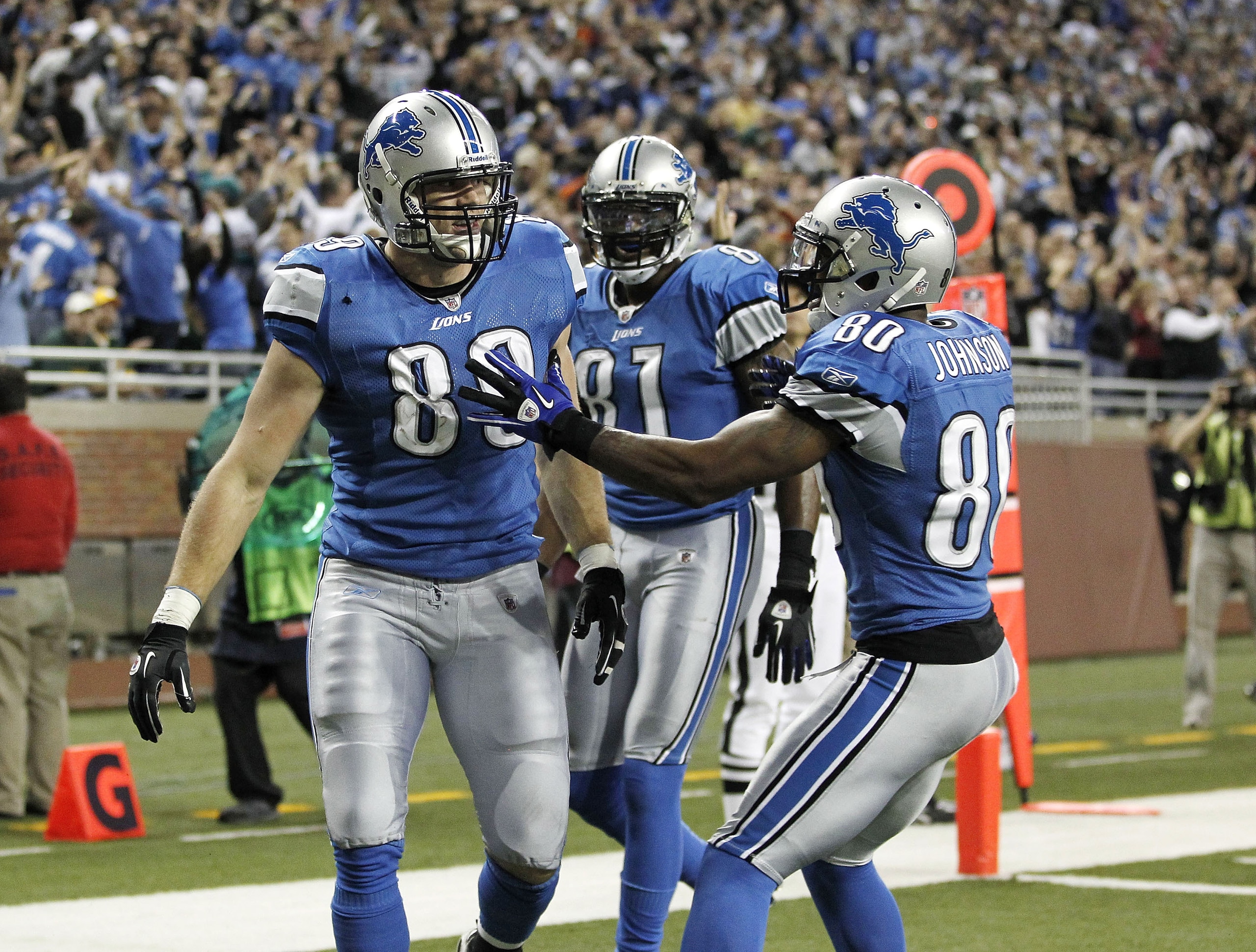 DETROIT, MI - DECEMBER 12: Will Heller #89 of the Detroit Lions celebrates a for a fourth quarter touchdown with Bryant Johnson #80 and Calvin Johnson #81 while playing the Green Bay Packers on December 12, 2010 at Ford Field in Detroit, Michigan. Detroi DETROIT, MI - DECEMBER 12: Will Heller #89 of the Detroit Lions celebrates a for a fourth quarter touchdown with Bryant Johnson #80 and Calvin Johnson #81 while playing the Green Bay Packers on December 12, 2010 at Ford Field in Detroit, Michigan. Detroi