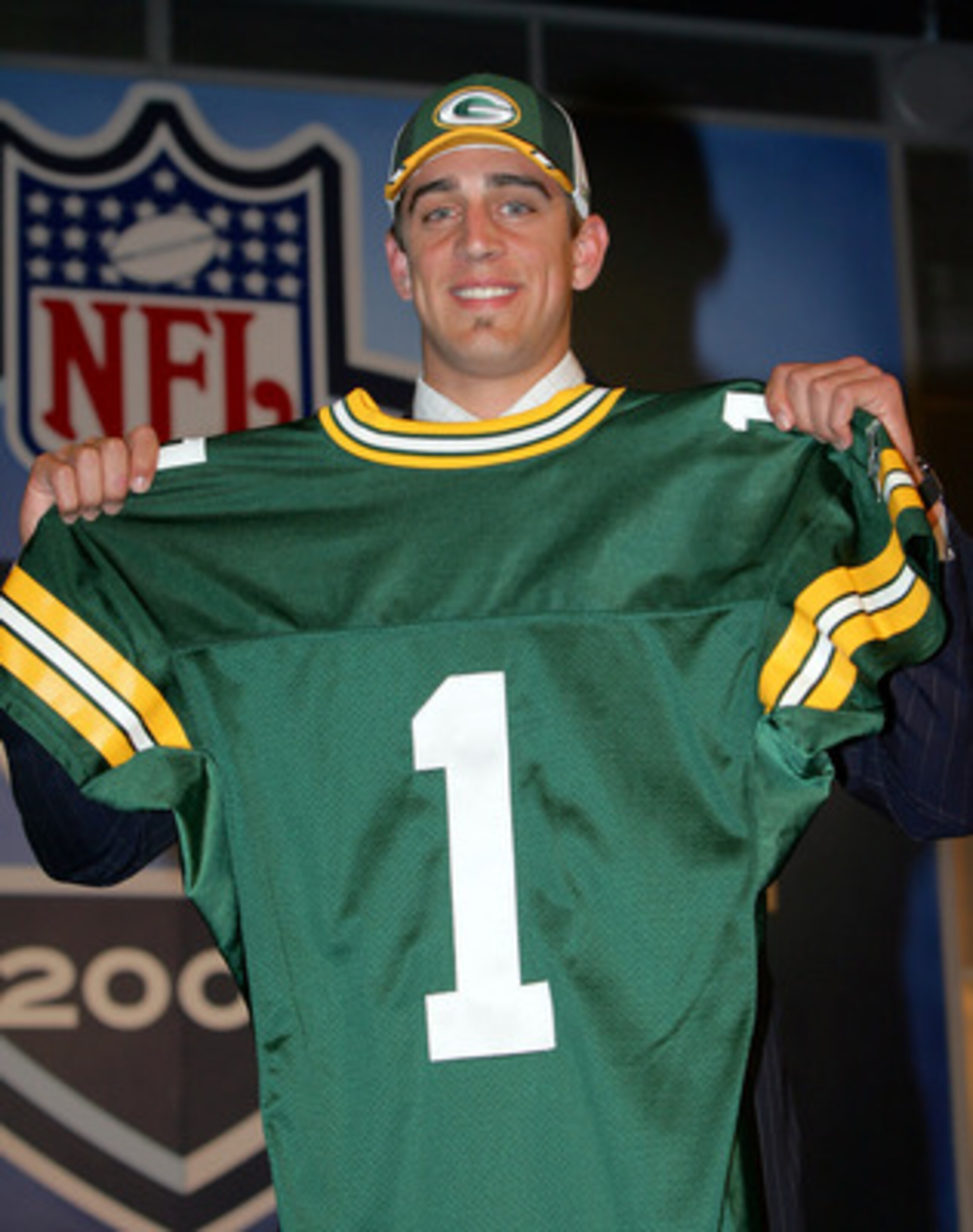NEW YORK - APRIL 23:  Quarterback Aaron Rodgers (California) poses with his jersey after being drafted 24th overall by the Green Bay Packers during the 70th NFL Draft on April 23, 2005 at the Jacob K. Javits Convention Center in New York City.  (Photo by 