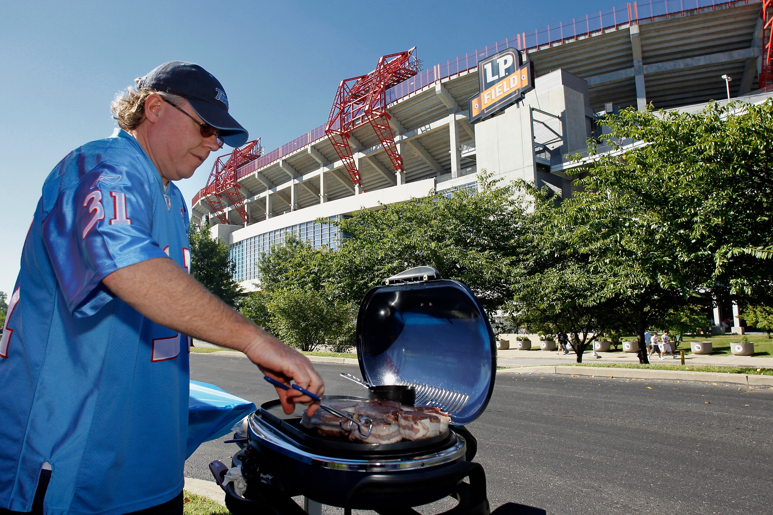 NASHVILLE - SEPTEMBER 12: A Tennessee Titans fan grills outside the stadium before the NFL season opener against the Oakland Raiders at LP Field on September 12, 2010 in Nashville, Tennessee. (Photo by Joe Robbins/Getty Images)