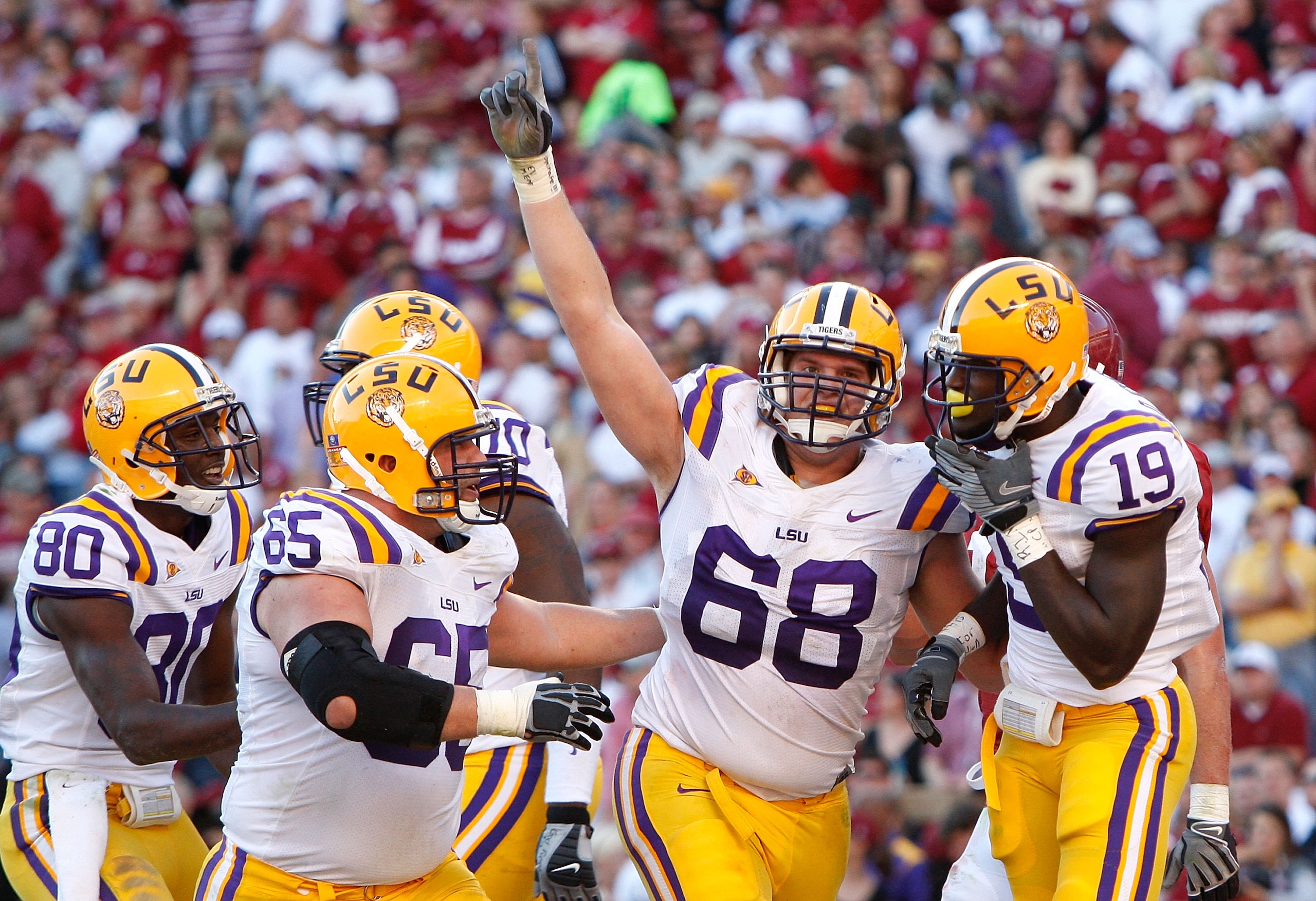 TUSCALOOSA, AL - NOVEMBER 07: Deangelo Peterson #19 of the Louisiana State University Tigers celebrates his touchdown against the Alabama Crimson Tide with Josh Dworaczyk #68, Lyle Hitt #65 and Terrance Toliver #80 at Bryant-Denny Stadium on November 7, TUSCALOOSA, AL - NOVEMBER 07: Deangelo Peterson #19 of the Louisiana State University Tigers celebrates his touchdown against the Alabama Crimson Tide with Josh Dworaczyk #68, Lyle Hitt #65 and Terrance Toliver #80 at Bryant-Denny Stadium on November 7,