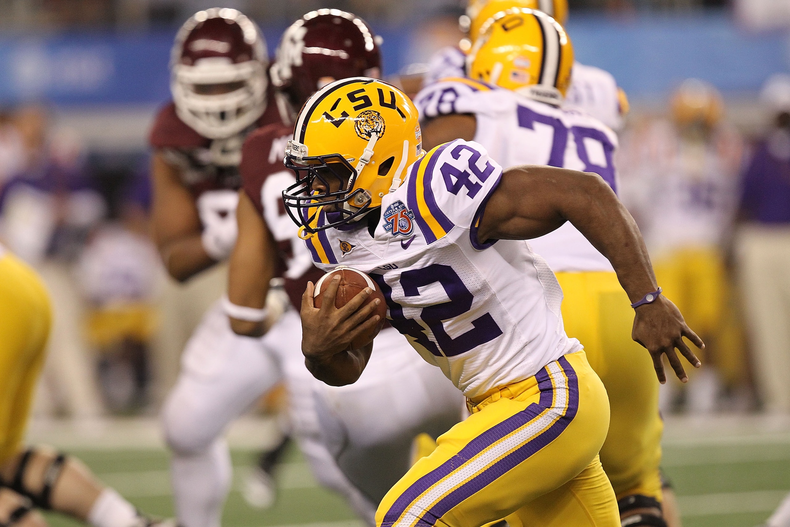 ARLINGTON, TX - JANUARY 07: Running back Michael Ford #42 of the LSU Tigers runs the ball against the Texas A&M Aggies during the AT&T Cotton Bowl at Cowboys Stadium on January 7, 2011 in Arlington, Texas. (Photo by Ronald Martinez/Getty Images) ARLINGTON, TX - JANUARY 07: Running back Michael Ford #42 of the LSU Tigers runs the ball against the Texas A&M Aggies during the AT&T Cotton Bowl at Cowboys Stadium on January 7, 2011 in Arlington, Texas. (Photo by Ronald Martinez/Getty Images)