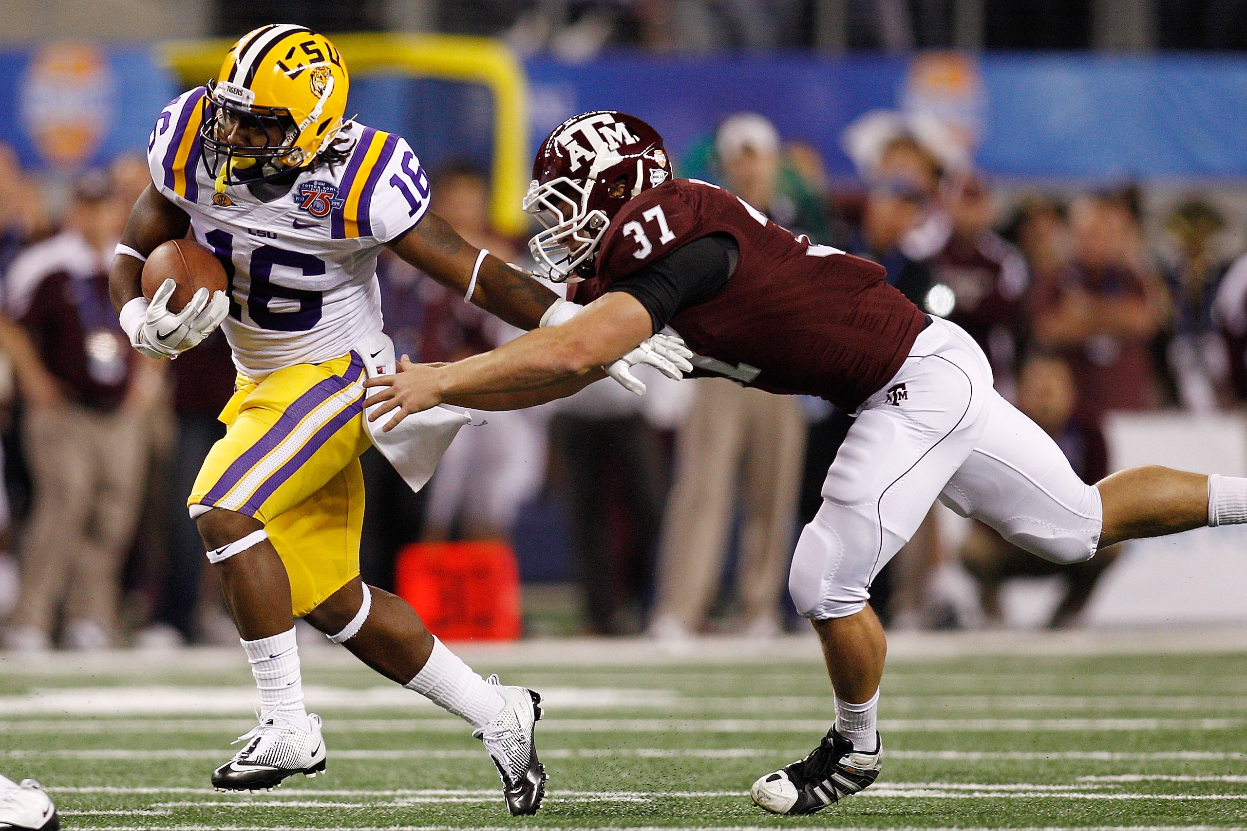 ARLINGTON, TX - JANUARY 07: Spencer Ware #16 of the Louisiana State University Tigers is tackled by Michael Hodges #37 of the Texas A&M Aggies during the AT&T Cotton Bowl at Cowboys Stadium on January 7, 2011 in Arlington, Texas. (Photo by Chris Graythe ARLINGTON, TX - JANUARY 07: Spencer Ware #16 of the Louisiana State University Tigers is tackled by Michael Hodges #37 of the Texas A&M Aggies during the AT&T Cotton Bowl at Cowboys Stadium on January 7, 2011 in Arlington, Texas. (Photo by Chris Graythe