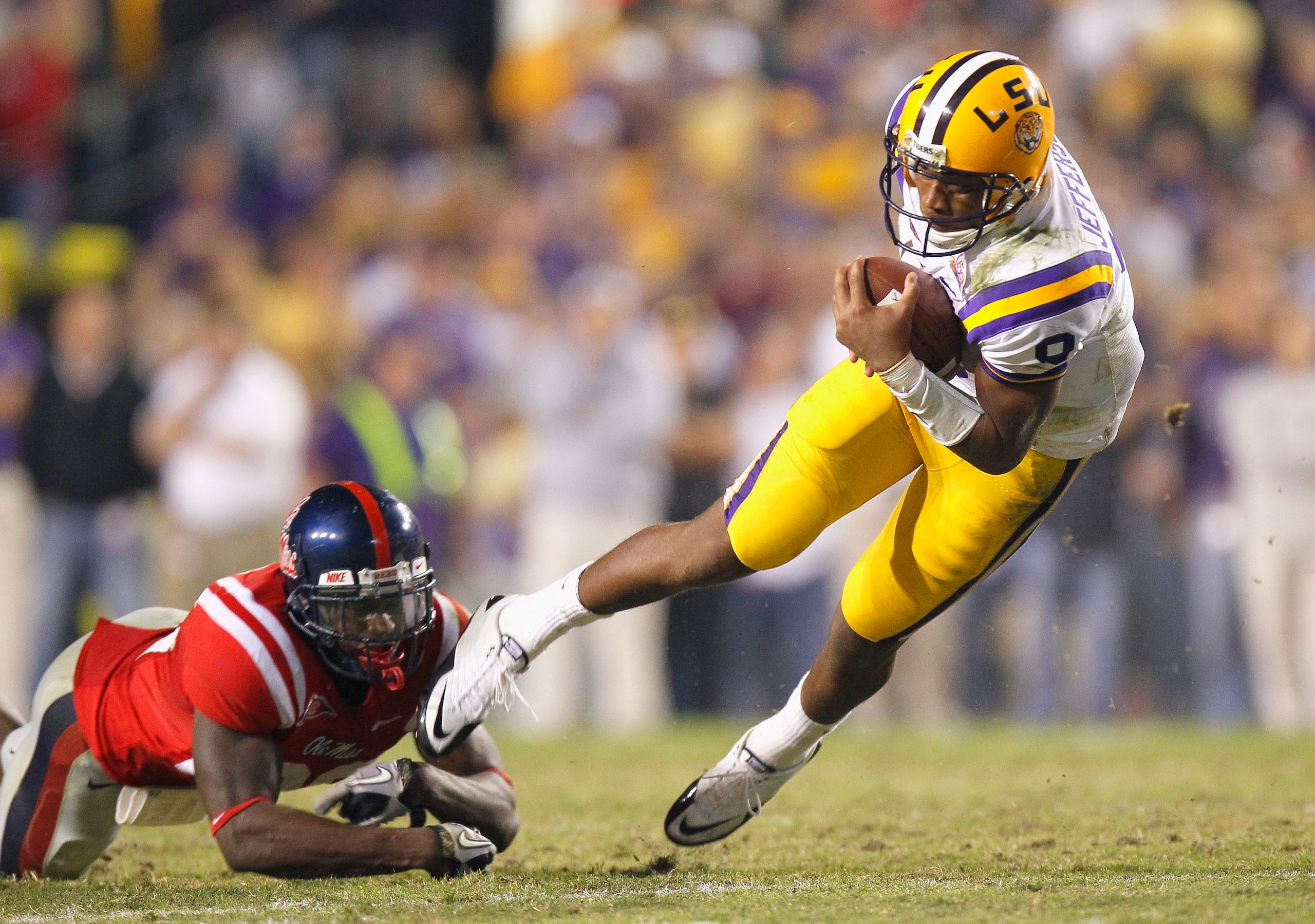 BATON ROUGE, LA - NOVEMBER 20: Quarterback Jordan Jefferson #9 of the Louisiana State University Tigers is tripped up by Johnny Brown #20 of the Ole Miss Rebels at Tiger Stadium on November 20, 2010 in Baton Rouge, Louisiana. (Photo by Kevin C. Cox/Gett BATON ROUGE, LA - NOVEMBER 20: Quarterback Jordan Jefferson #9 of the Louisiana State University Tigers is tripped up by Johnny Brown #20 of the Ole Miss Rebels at Tiger Stadium on November 20, 2010 in Baton Rouge, Louisiana. (Photo by Kevin C. Cox/Gett