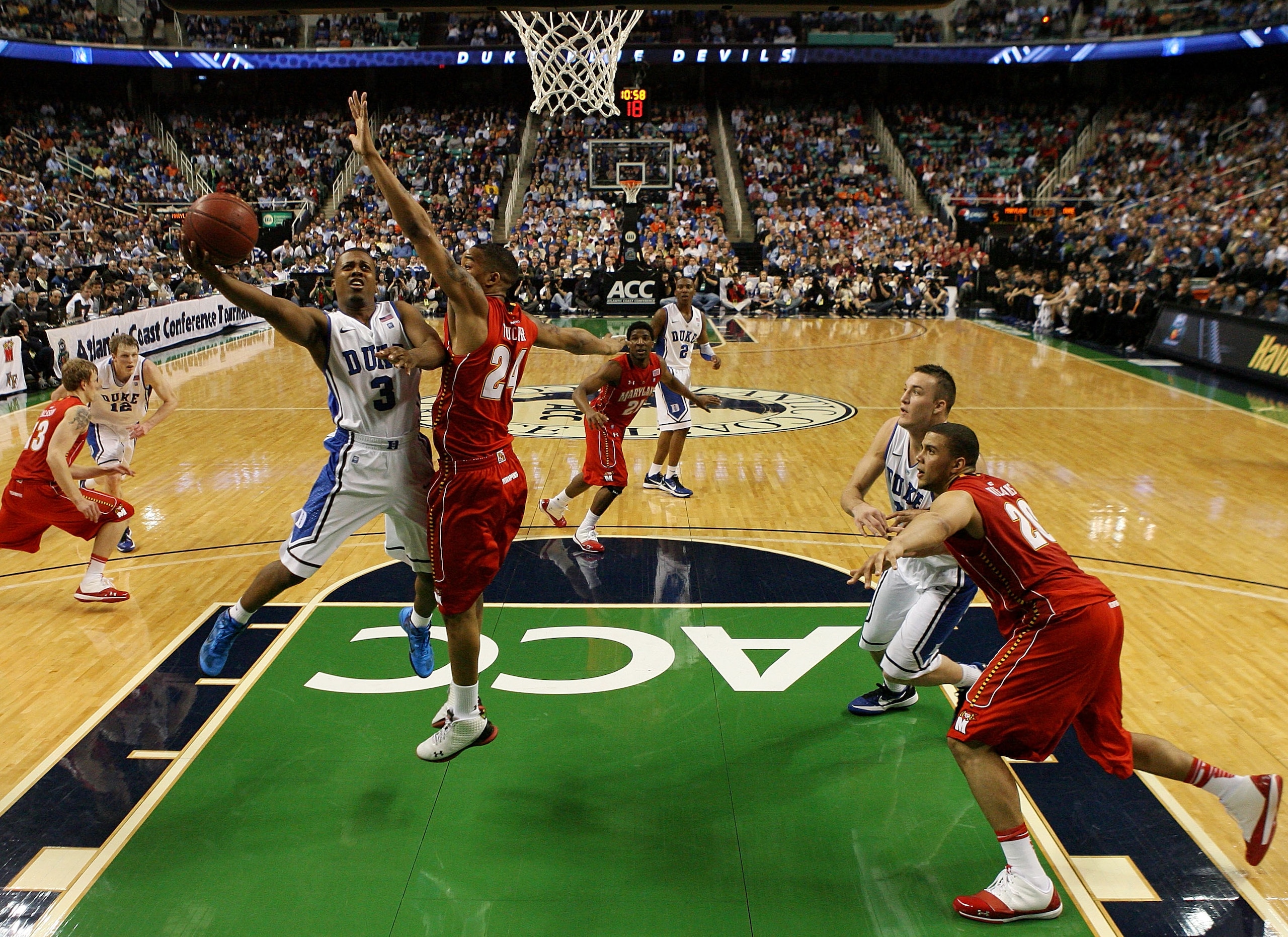 GREENSBORO, NC - MARCH 11:  Tyler Thornton #3 of the Duke Blue Devils shoots against Cliff Tucker #24 of the Maryland Terrapins during the second half in the quarterfinals of the 2011 ACC men's basketball tournament at the Greensboro Coliseum on March 11,