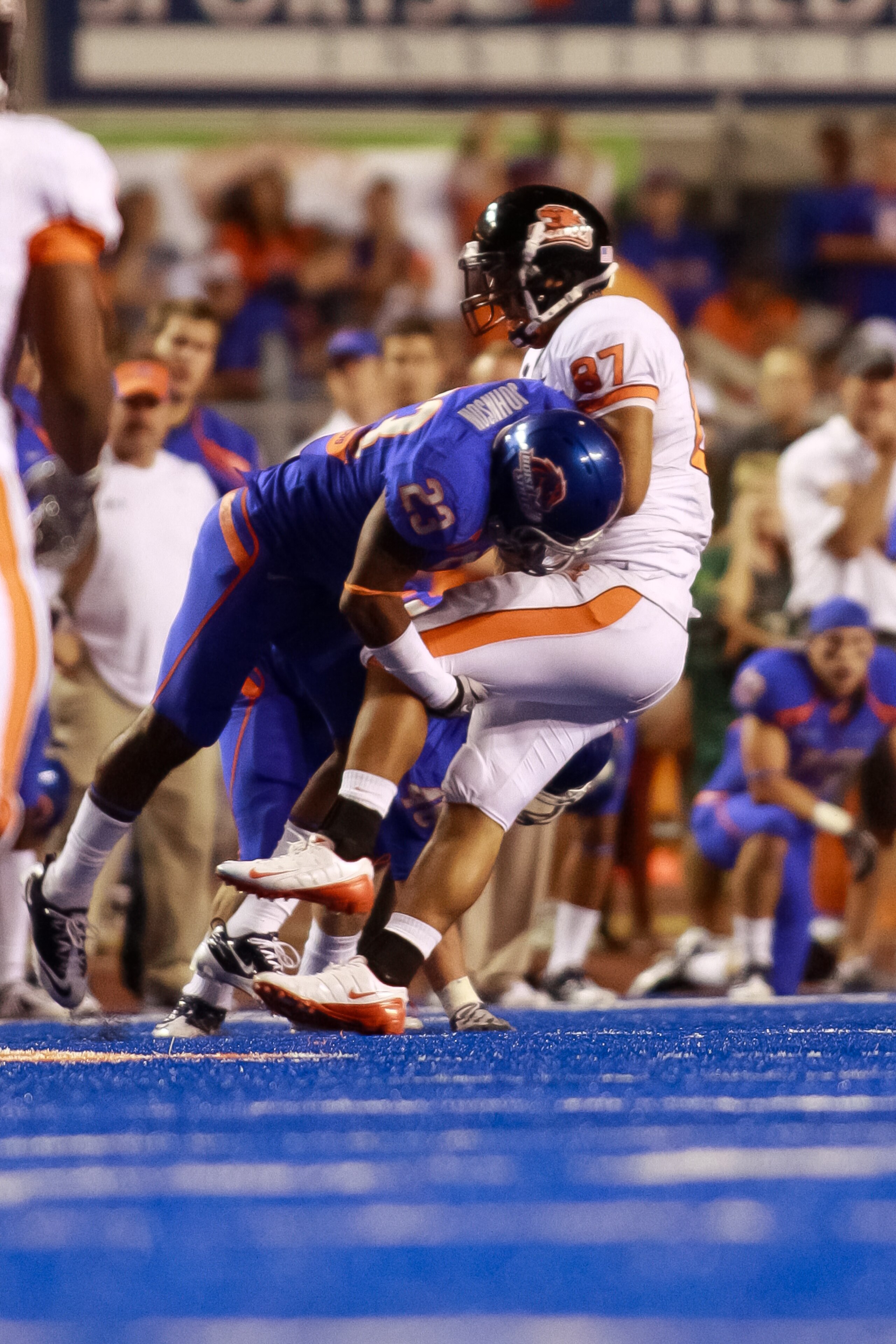 BOISE, ID - SEPTEMBER 25:  Tight end Joe Halahuni #87 of the Oregon State Beavers is tackled by safety Jeron Johnson #23 of the Boise State Broncos at Bronco Stadium on September 25, 2010 in Boise, Idaho.  (Photo by Otto Kitsinger III/Getty Images)