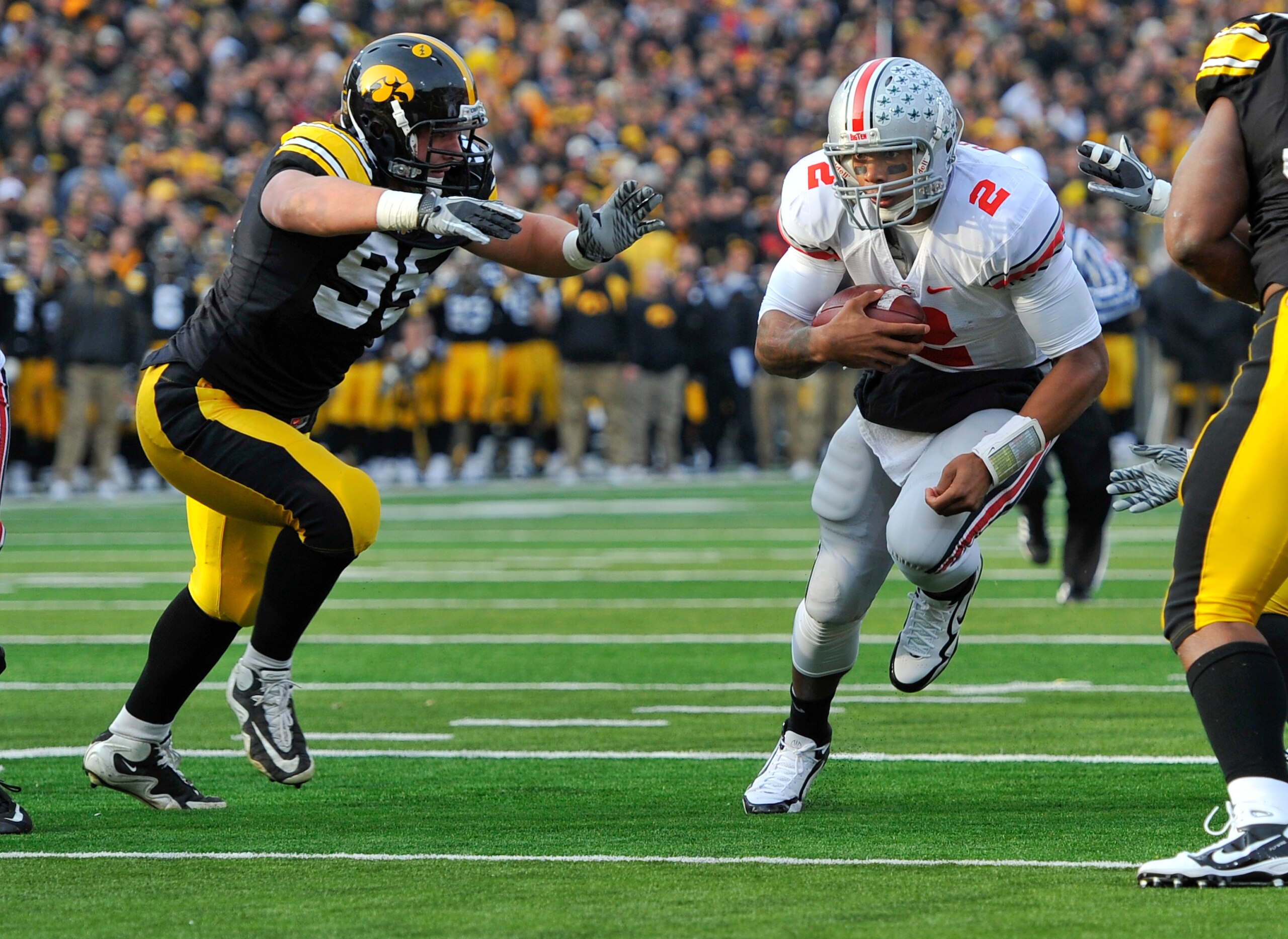 IOWA CITY, IA - NOVEMBER 20:  Defeisive lineman Karl Klug #95 of the University of Iowa Hawkeyes close in for the tackle on quarterback Terrelle Pryor #2 of the Ohio State Buckeyes as he drive the ball towards the goal line during the first half of play a