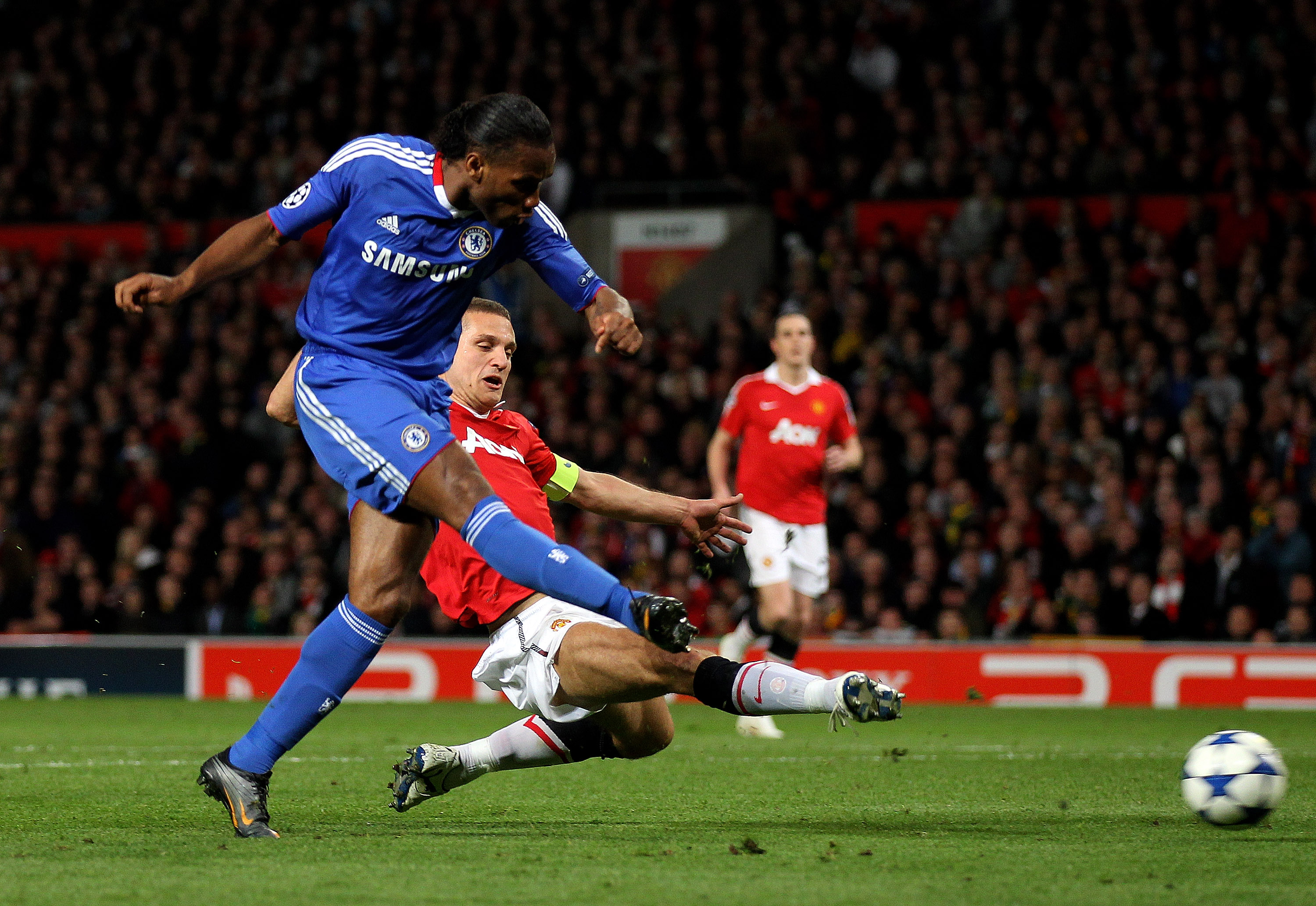 MANCHESTER, ENGLAND - APRIL 12:  Didier Drogba of Chelsea scores his team's first goal during the UEFA Champions League Quarter Final second leg match between Manchester United and Chelsea at Old Trafford on April 12, 2011 in Manchester, England.  (Photo 