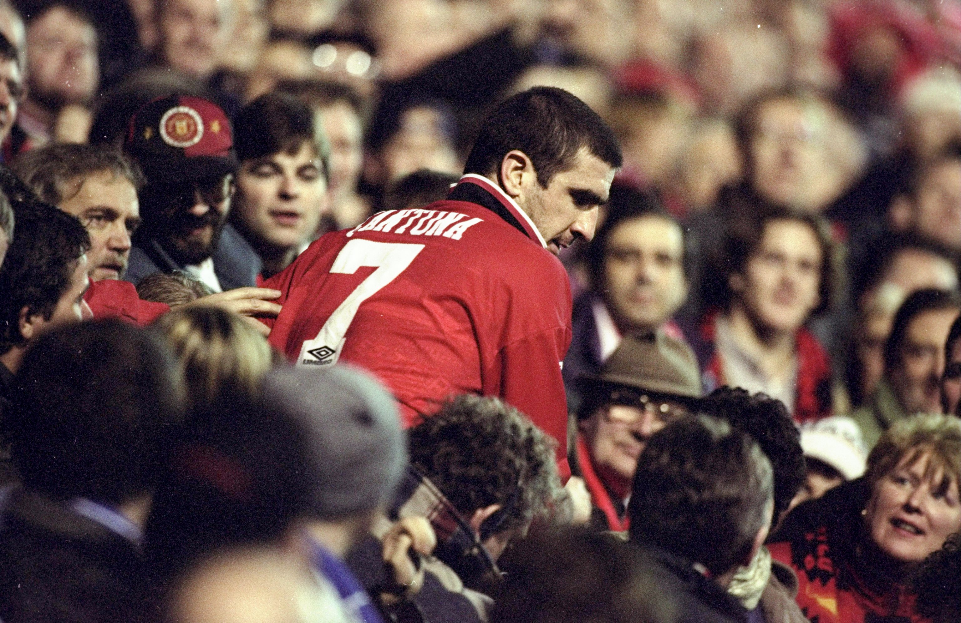 12 Dec 1995:  Eric Cantona of Manchester United is surrounded by the fans after an FA Carling Premiership match against Chelsea at Old Trafford in Manchester, England. The match ended in a 1-1 draw. \ Mandatory Credit: Ross  Kinnaird/Allsport