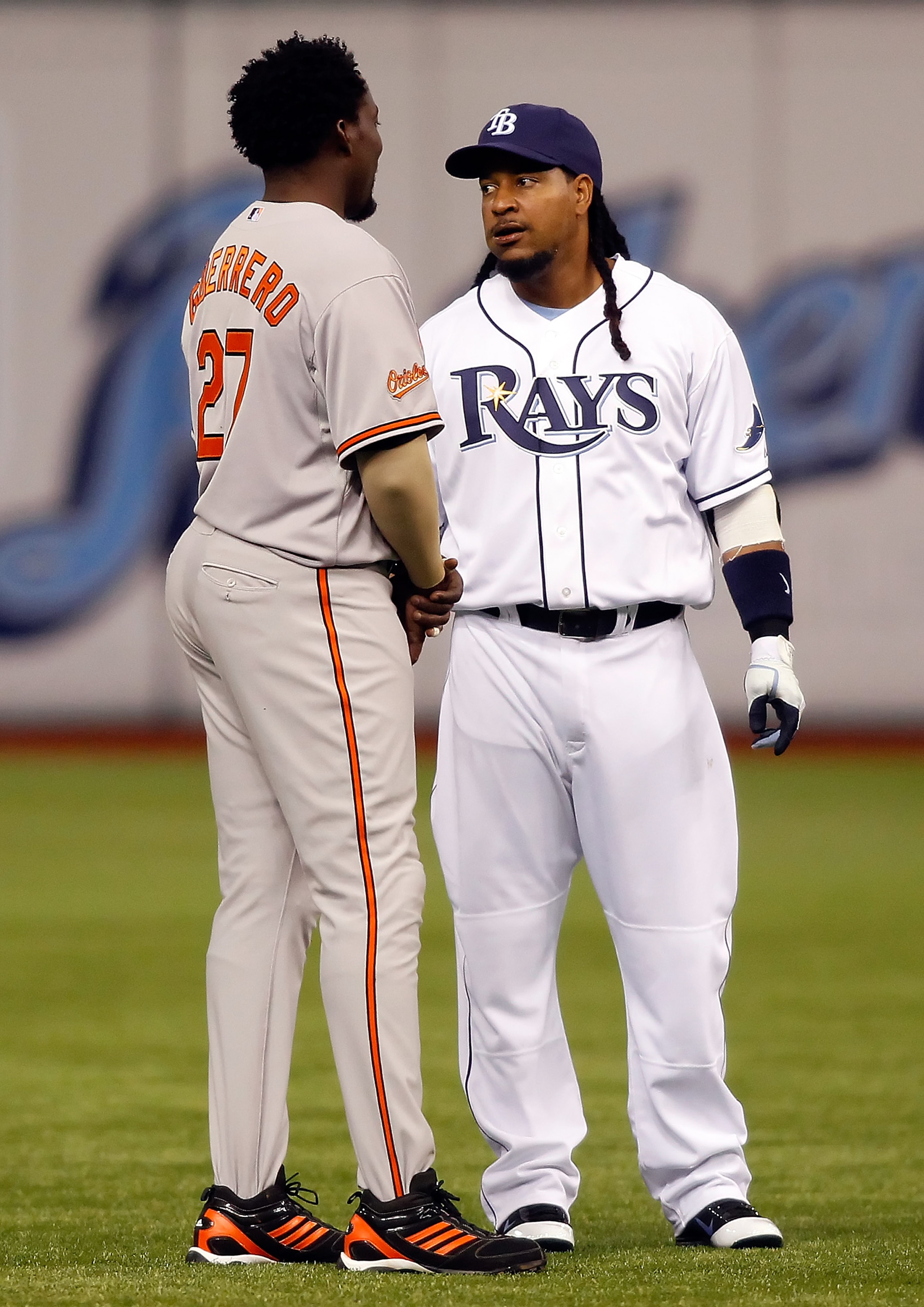 ST. PETERSBURG, FL - APRIL 02:  Designated hitter Manny Ramirez #24 of the Tampa Bay Rays talks with designated hitter Vladimir Guerrero #27 of the Baltimore Orioles just before the start of the game at Tropicana Field on April 2, 2011 in St. Petersburg,
