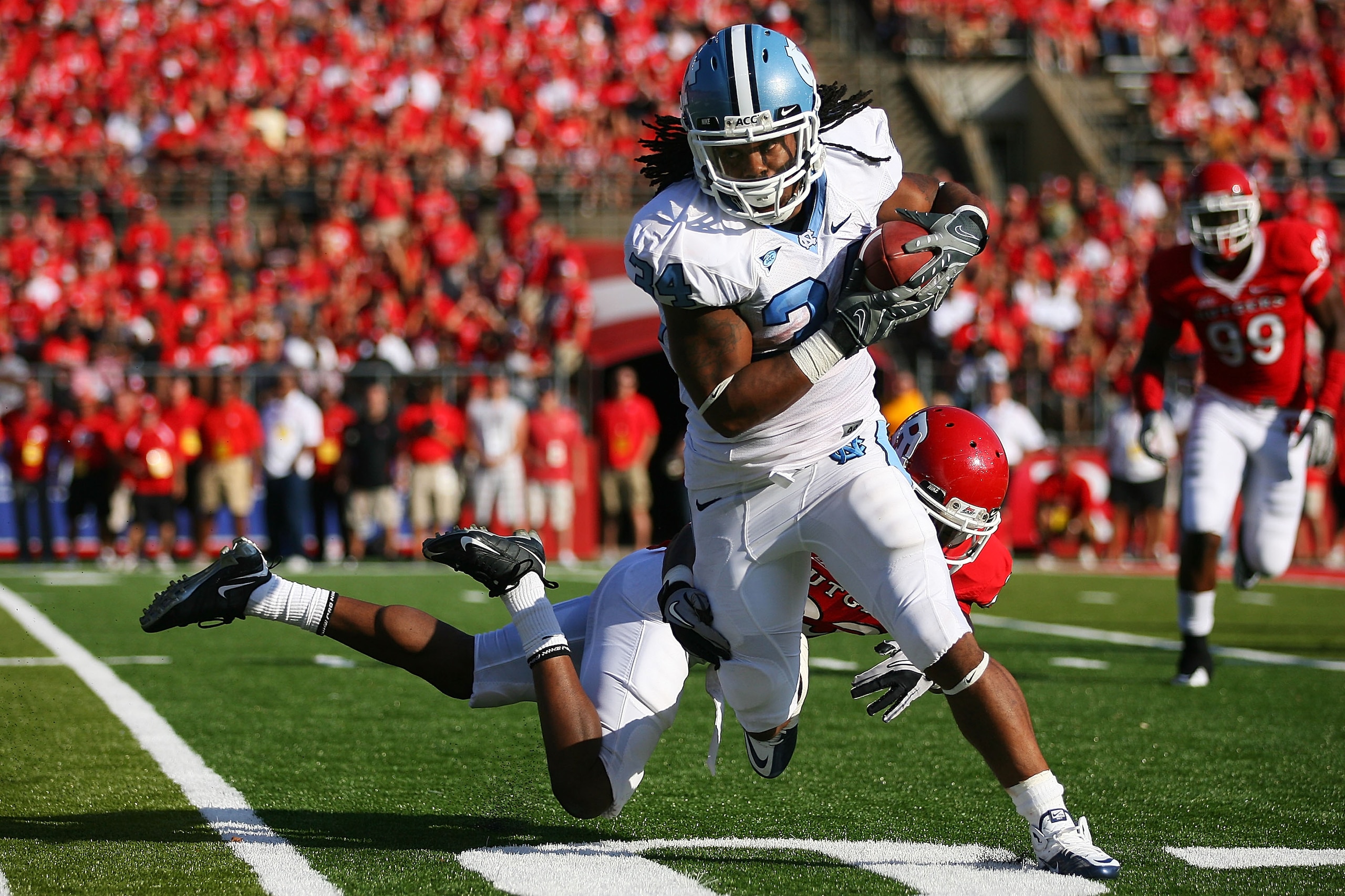 NEW BRUNSWICK, NJ - SEPTEMBER 25: Brandon Bing #23 of the Rutgers Scarlet Knights is unable to tackle Johnny White #34 of the North Carolina Tar Heels during the second quarter at Rutgers Stadium on September 25, 2010 in New Brunswick, New Jersey.  (Photo