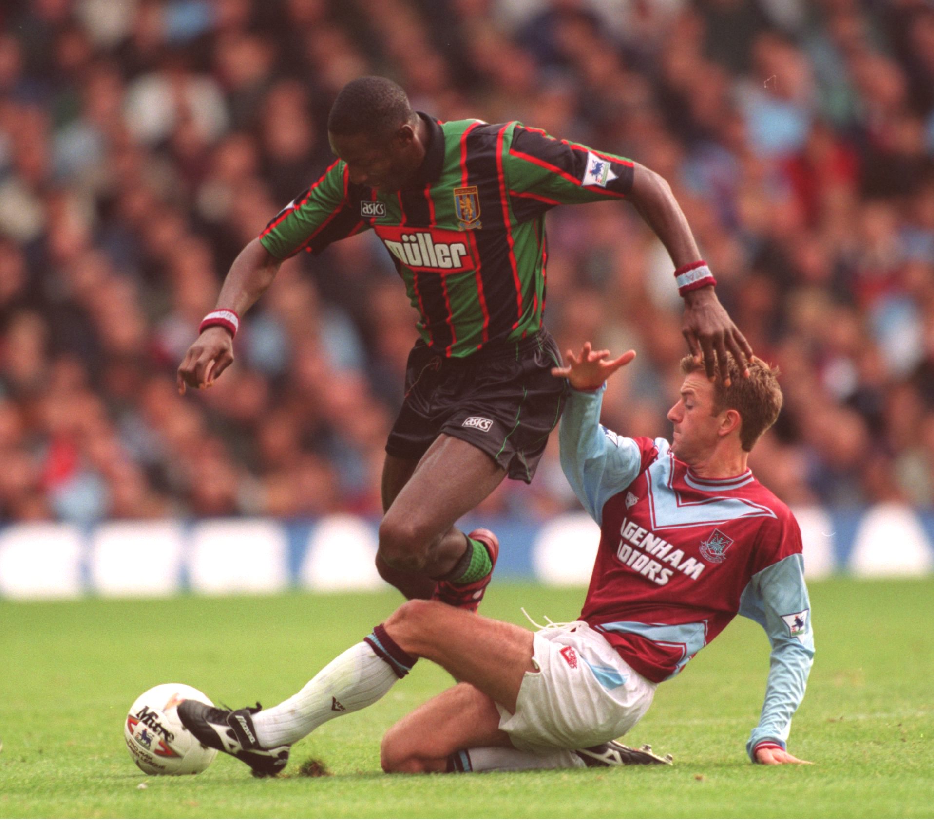 17 SEP1994:  JOHN FASHANU OF WIMBLEDON IS TACKLED BY KEITH ROWLAND OF WEST HAM DURING THEIR ENGLISH FA PREMIERSHIP MATCH AGAINST ASTON VILLA AT UPTON PARK IN LONDON. Mandatory Credit: Mike Hewitt/ALLSPORT