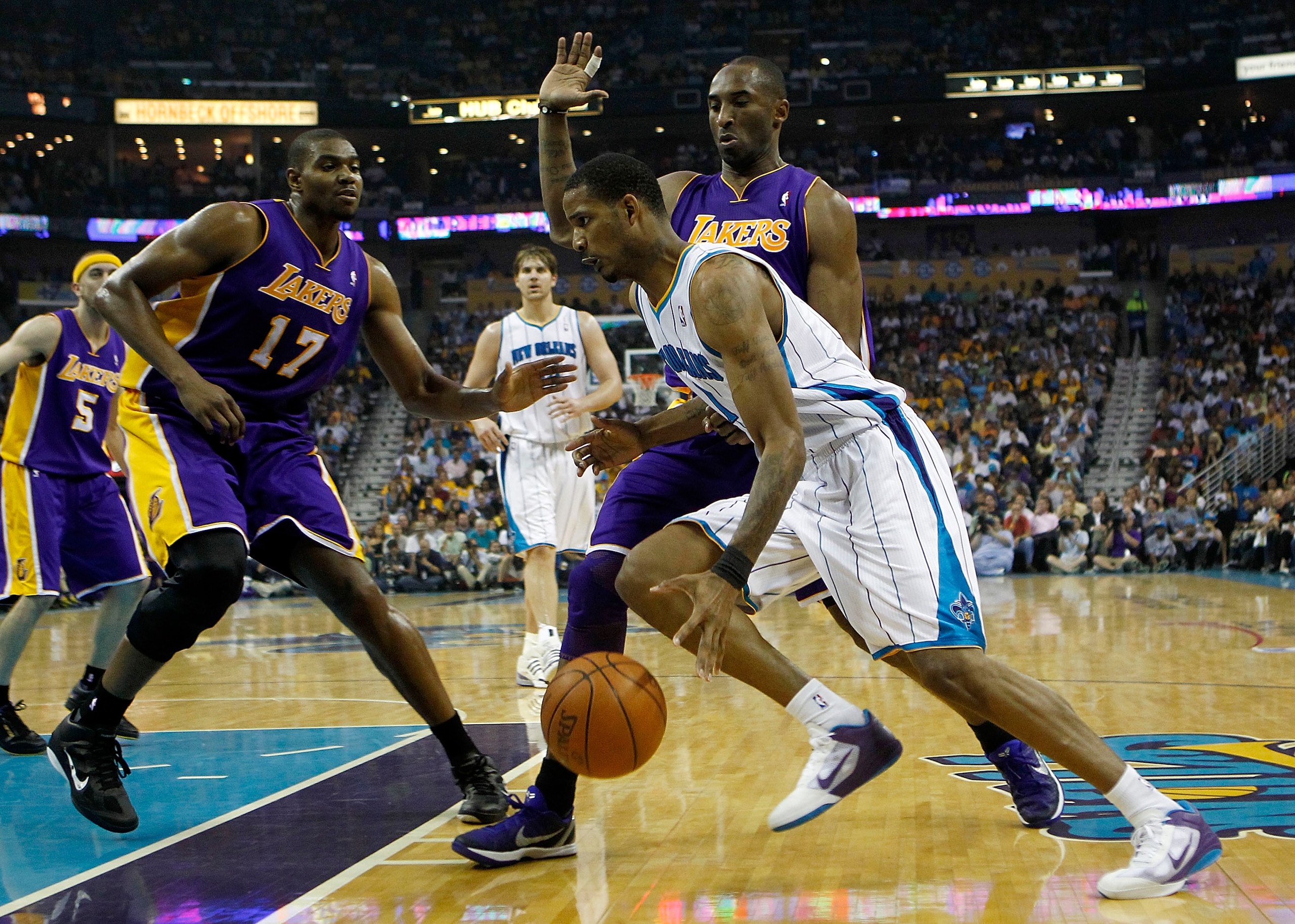 NEW ORLEANS - APRIL 24: Trevor Ariza #1 of the New Orleans Hornets drives by Kobe Bryant #24 and Andrew Bynum #17 of the Los Angeles Lakers in Game Four of the Western Conference Quarterfinals in the 2011 NBA Playoffs at New Orleans Arena on April 24, 20 NEW ORLEANS - APRIL 24: Trevor Ariza #1 of the New Orleans Hornets drives by Kobe Bryant #24 and Andrew Bynum #17 of the Los Angeles Lakers in Game Four of the Western Conference Quarterfinals in the 2011 NBA Playoffs at New Orleans Arena on April 24, 20