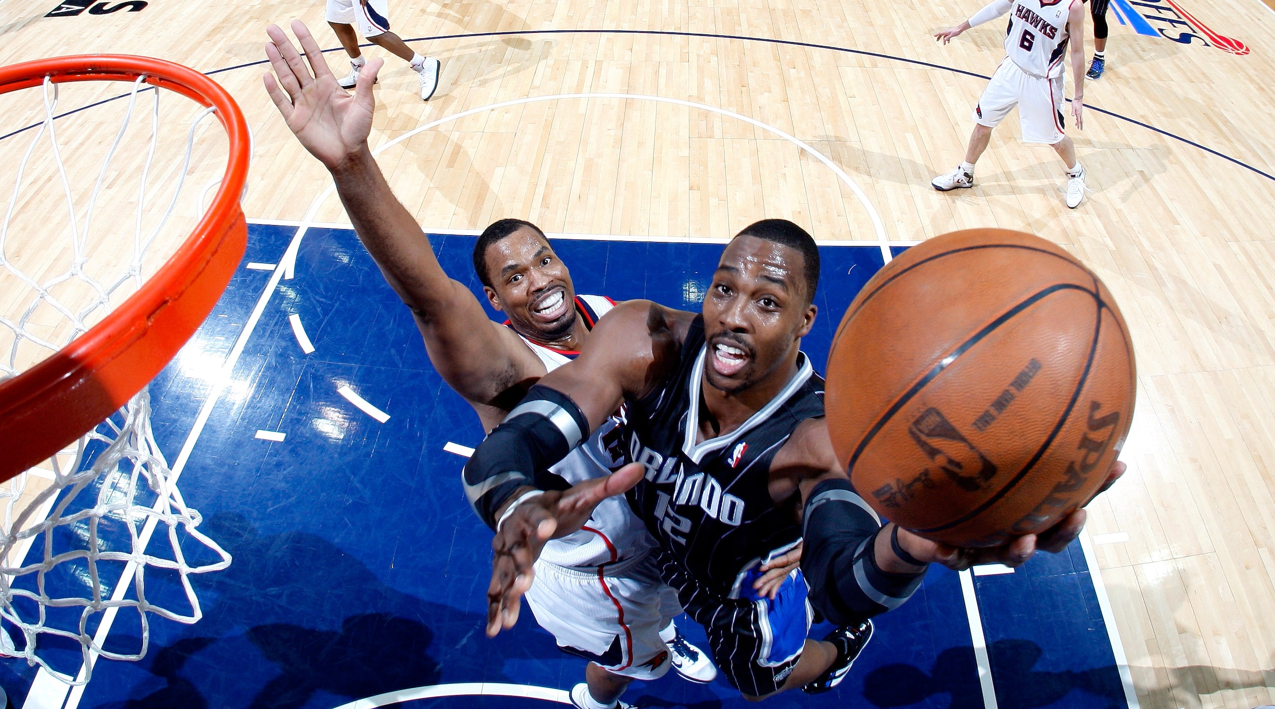 ATLANTA, GA - APRIL 24: Dwight Howard #12 of the Orlando Magic attacks the basket against Jason Collins #34 of the Atlanta Hawks during Game Four of the Eastern Conference Quarterfinals in the 2011 NBA Playoffs at Philips Arena on April 24, 2011 in Atlan ATLANTA, GA - APRIL 24: Dwight Howard #12 of the Orlando Magic attacks the basket against Jason Collins #34 of the Atlanta Hawks during Game Four of the Eastern Conference Quarterfinals in the 2011 NBA Playoffs at Philips Arena on April 24, 2011 in Atlan