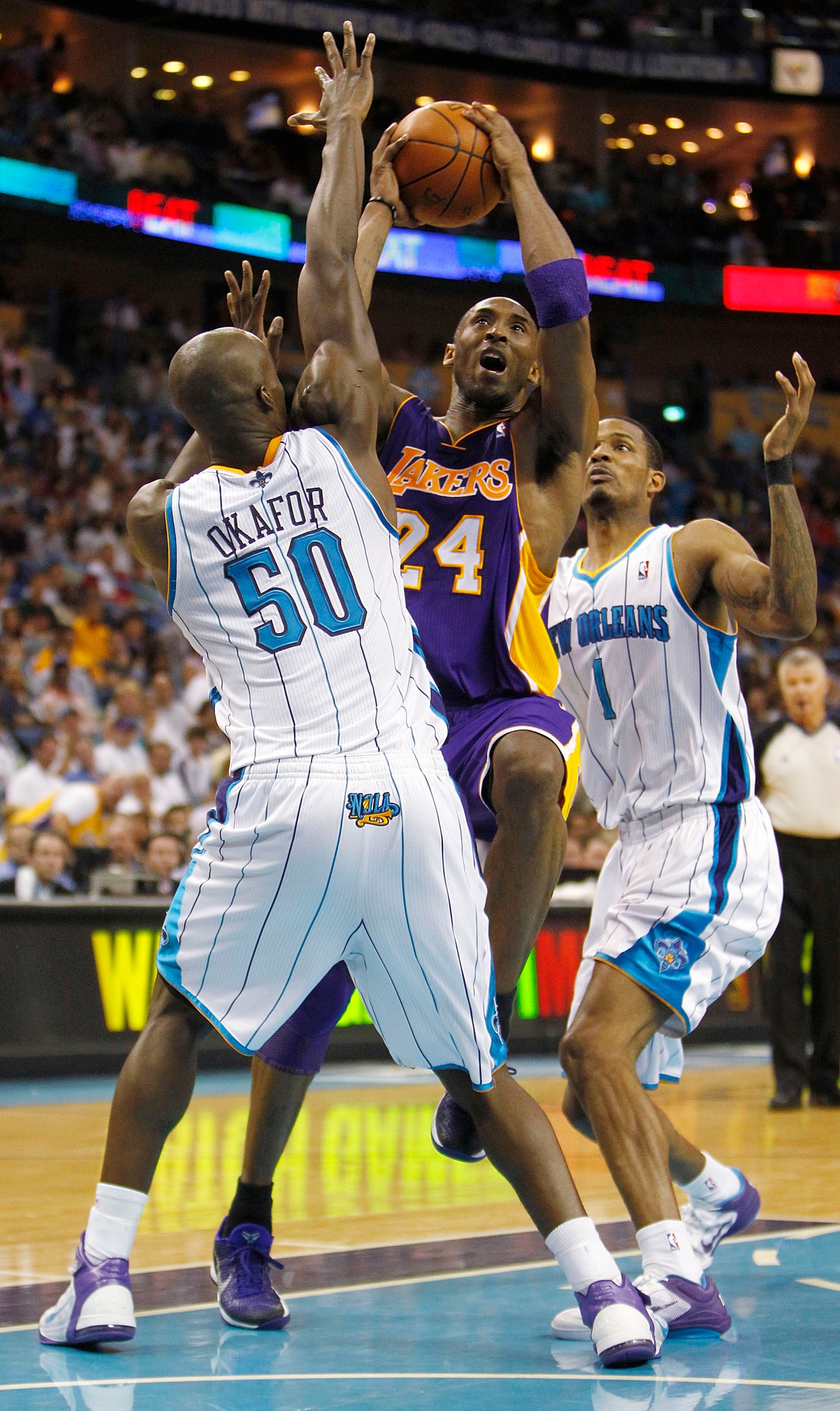 NEW ORLEANS - APRIL 24: Kobe Bryant #24 of the Los Angeles Lakers drives between Emeka Okafor #50 and Trevor Ariza #1 of the New Orleans Hornets in Game Four of the Western Conference Quarterfinals in the 2011 NBA Playoffs at New Orleans Arena on April 2 NEW ORLEANS - APRIL 24: Kobe Bryant #24 of the Los Angeles Lakers drives between Emeka Okafor #50 and Trevor Ariza #1 of the New Orleans Hornets in Game Four of the Western Conference Quarterfinals in the 2011 NBA Playoffs at New Orleans Arena on April 2