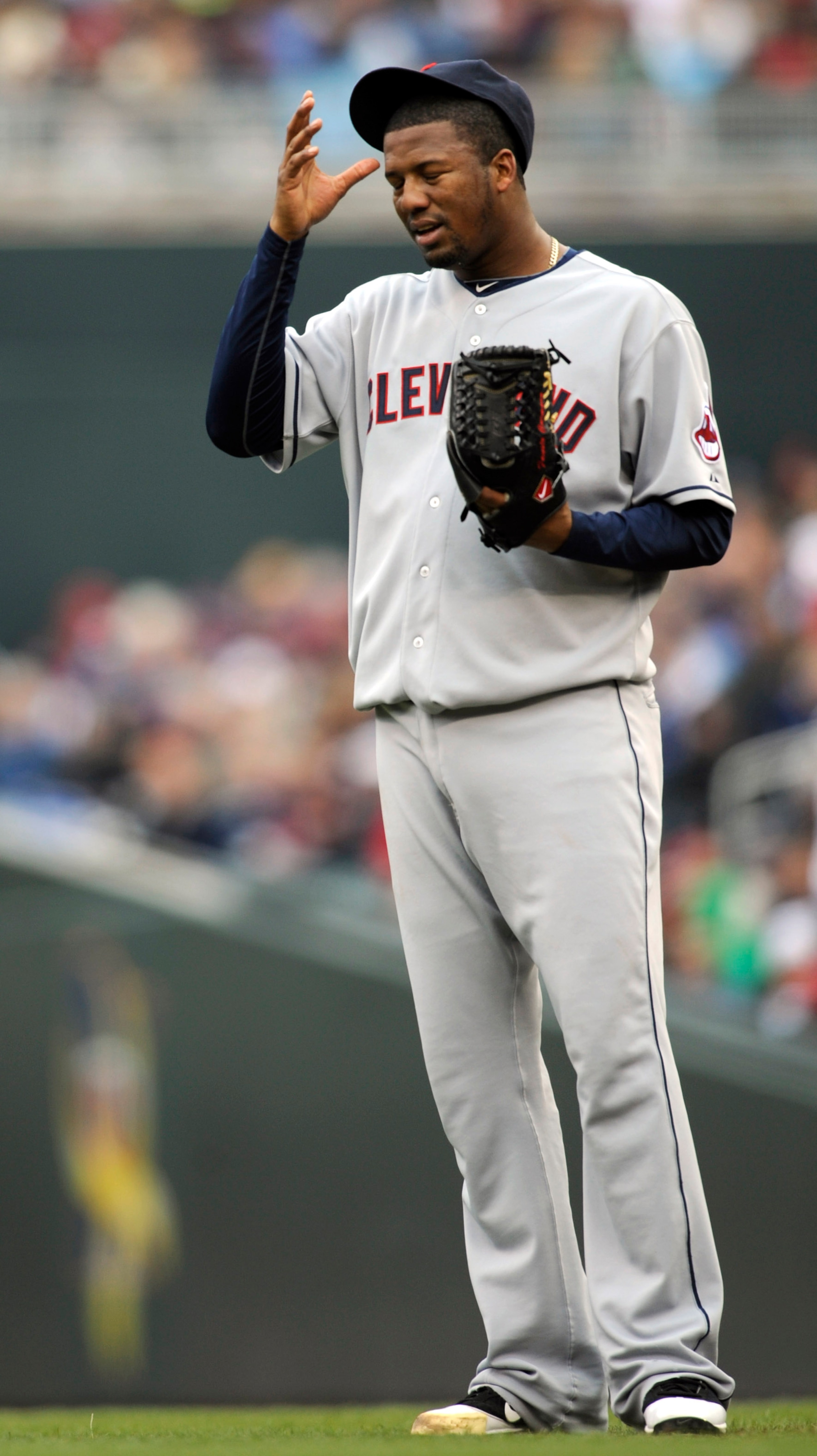 MINNEAPOLIS, MN - APRIL 23: Fausto Carmona #55 of the Cleveland Indians reacts to a wild pitch advancing a runner from second base to third base against the Minnesota Twins during the third inning of their game on April 23, 2011 at Target Field in Minneap