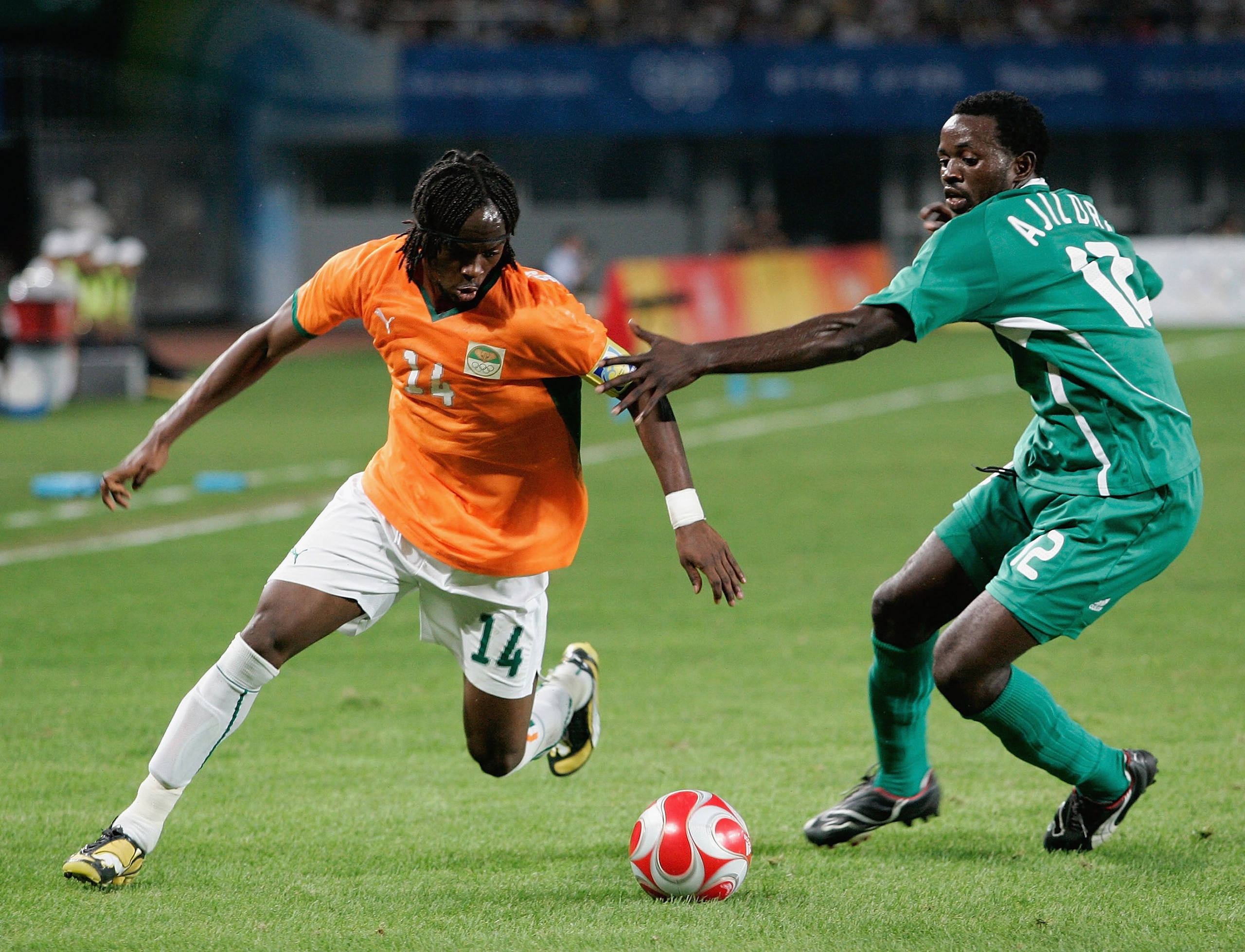 QINHUANGDAO, CHINA - AUGUST 16:  Gervinho of Ivory Coast and Ebenezer Ajilore of Nigeria  compete for the ball during the Men's Quarter Final match between Nigeria and Ivory Coast at Qinhuangdao Olympic Sports Center Stadium on Day 8 of the Beijing 2008 O