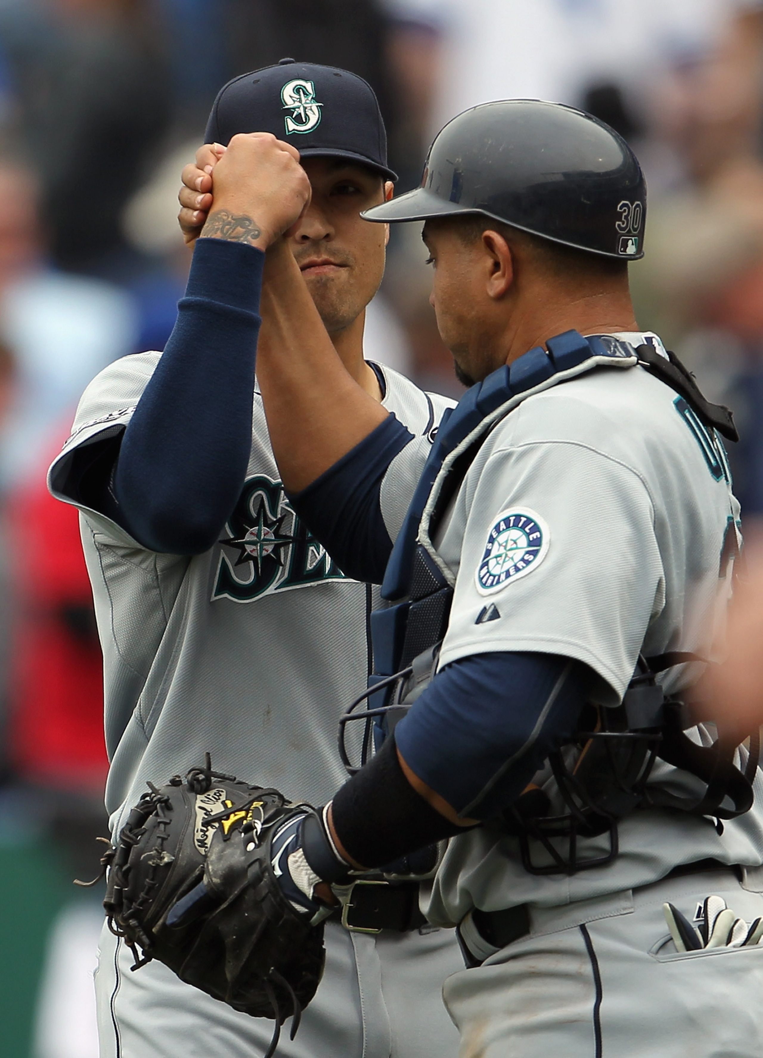 KANSAS CITY, MO - APRIL 17:  Relief pitcher Brandon League #43 of the Seattle Mariners celebrates with catcher Miguel Olivo #30 after the Mariners defeated the Kansas City Royals 3-2 to win the game on April 17, 2011 at Kauffman Stadium in Kansas City, Mi