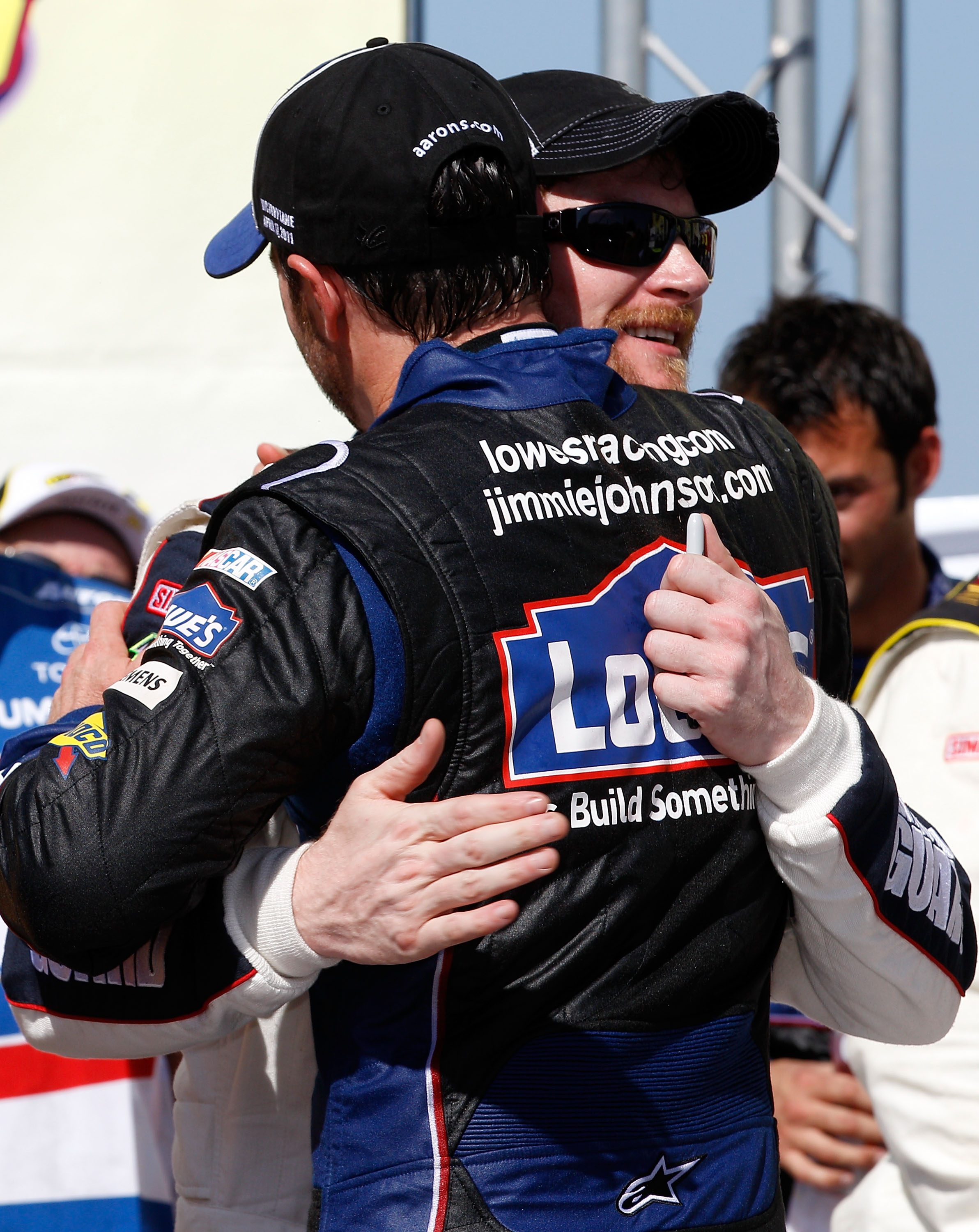 TALLADEGA, AL - APRIL 17:  Jimmie Johnson (FRONT), driver of the #48 Lowe's Chevrolet, hugs teammates Dale Earnhardt Jr. (BACK), driver of the #88 National Guard/Amp Energy Chevrolet, in Victory Lane after winning the NASCAR Sprint Cup Series Aaron's 499