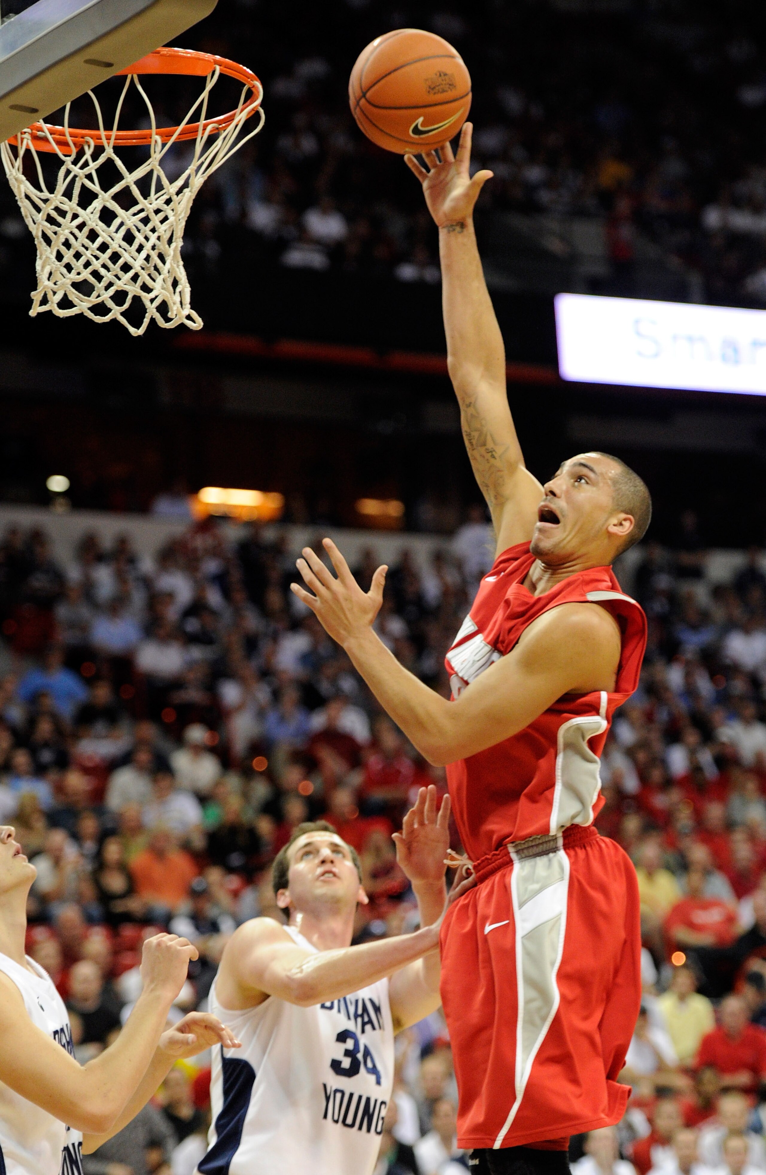 LAS VEGAS, NV - MARCH 11:  Drew Gordon #32 of the New Mexico Lobos shoots over Noah Hartsock #34 of the Brigham Young University Cougars during a semifinal game of the Conoco Mountain West Conference Basketball tournament at the Thomas & Mack Center March