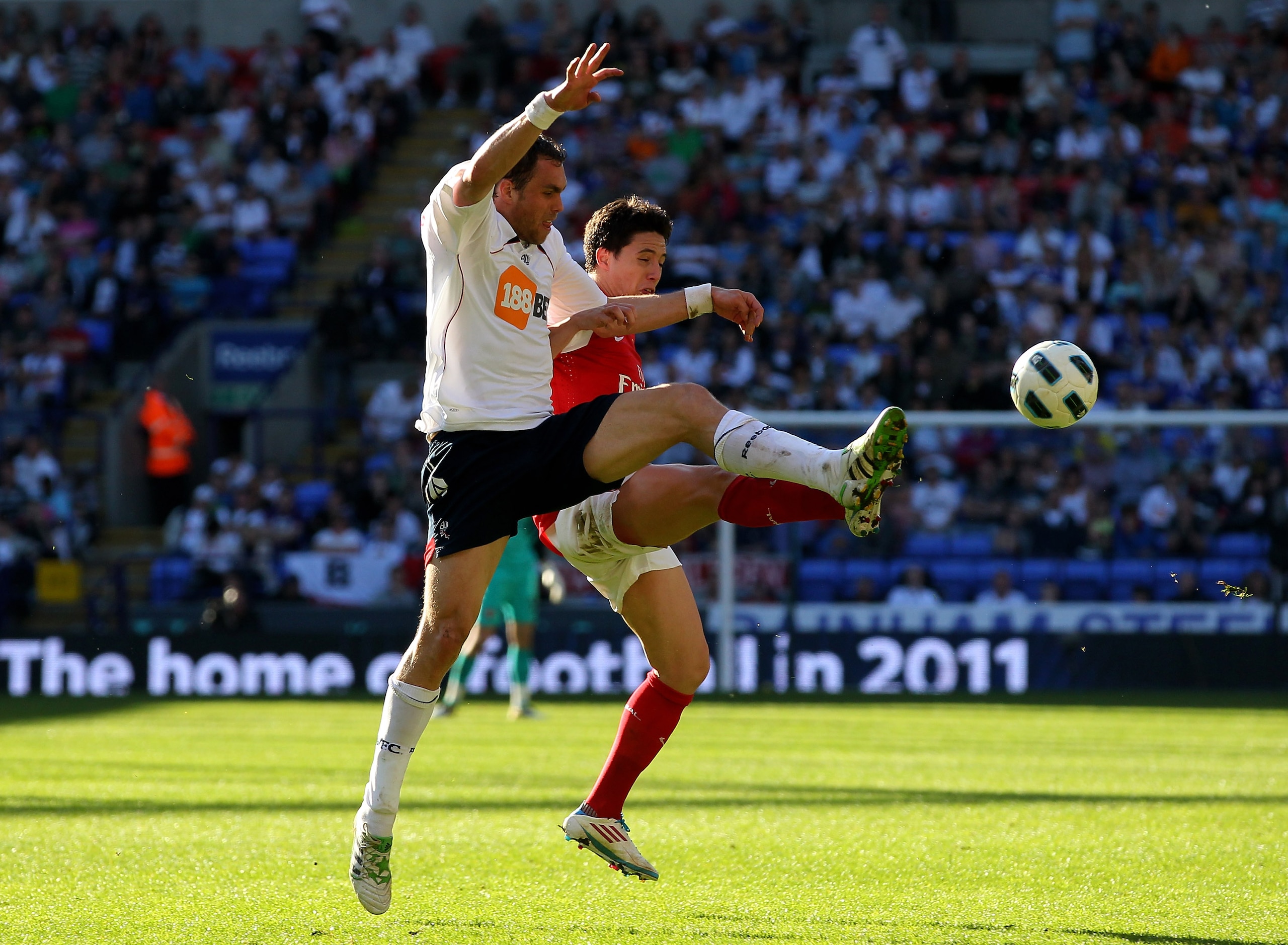 BOLTON, ENGLAND - APRIL 24:  Samir Nasri of Arsenal competes with Johan Elmander of Bolton Wanderers during the Barclays Premier League match between Bolton Wanderers and Arsenal at the Reebok Stadium on April 24, 2011 in Bolton, England.  (Photo by Clive