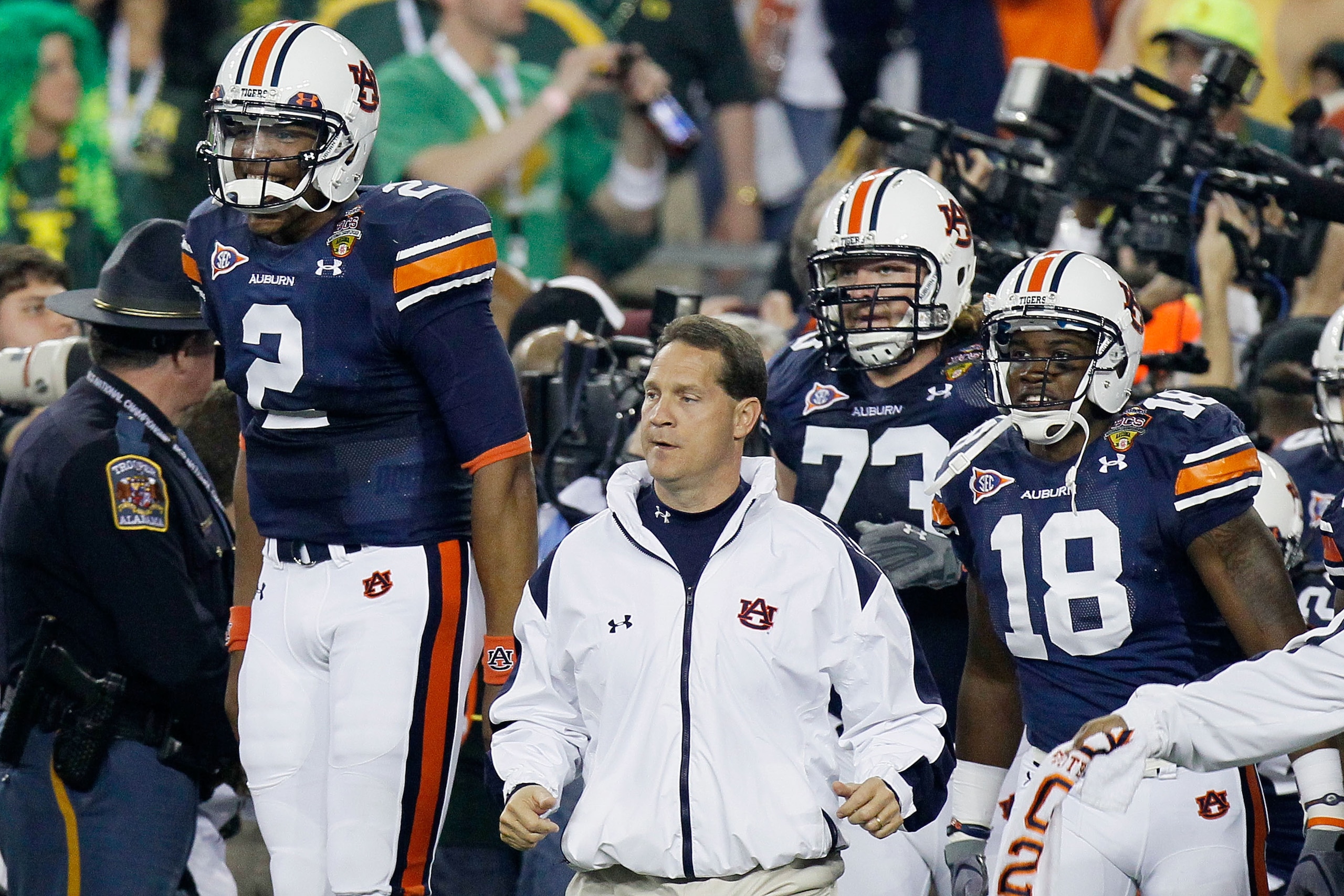 GLENDALE, AZ - JANUARY 10:  Cameron Newton #2, Head coach Gene Chizik, Lee Ziemba #73 and Kodi Burns #18 of the Auburn Tigers react on the sideline against the Oregon Ducks during the Tostitos BCS National Championship Game at University of Phoenix Stadiu