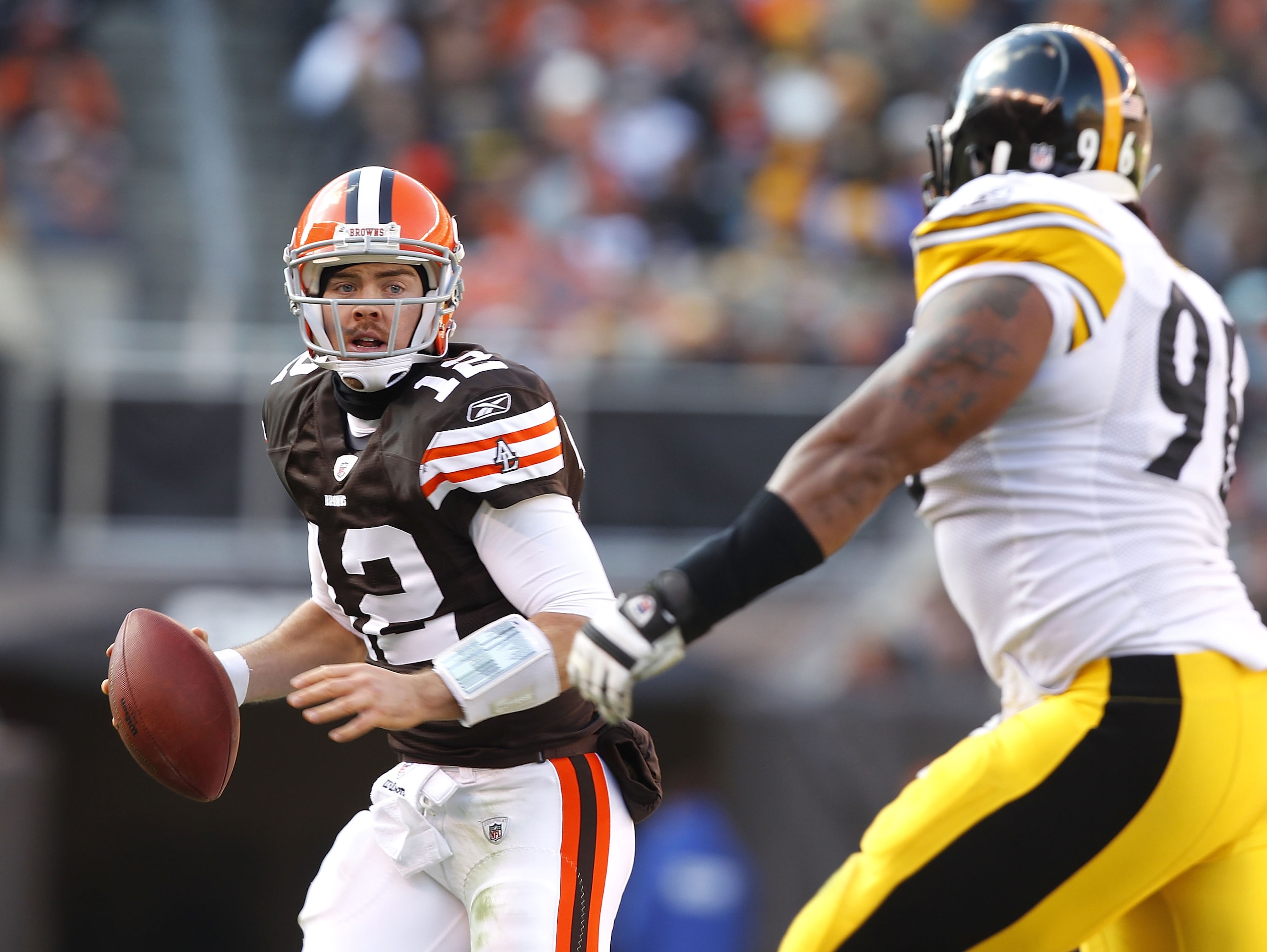 CLEVELAND, OH - JANUARY 02: Quarterback Colt McCoy #12 of the Cleveland Browns looks for a receiver as he is chased by defensive end Ziggy Hood #96 of the Pittsburgh Steelers at Cleveland Browns Stadium on January 2, 2011 in Cleveland, Ohio. (Photo by M CLEVELAND, OH - JANUARY 02: Quarterback Colt McCoy #12 of the Cleveland Browns looks for a receiver as he is chased by defensive end Ziggy Hood #96 of the Pittsburgh Steelers at Cleveland Browns Stadium on January 2, 2011 in Cleveland, Ohio. (Photo by M