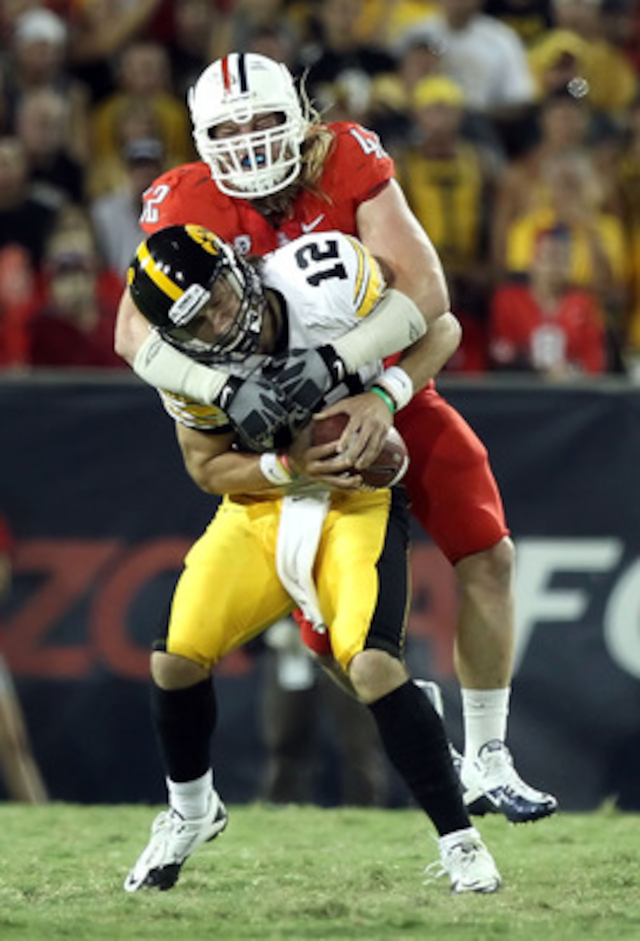 TUCSON, AZ - SEPTEMBER 18: Quarterback Ricky Stanzi #12 of the Iowa Hawkeyes is sacked by Brooks Reed #42 of the Arizona Wildcats during the third quarter of the college football game at Arizona Stadium on September 18, 2010 in Tucson, Arizona. The Wild TUCSON, AZ - SEPTEMBER 18: Quarterback Ricky Stanzi #12 of the Iowa Hawkeyes is sacked by Brooks Reed #42 of the Arizona Wildcats during the third quarter of the college football game at Arizona Stadium on September 18, 2010 in Tucson, Arizona. The Wild