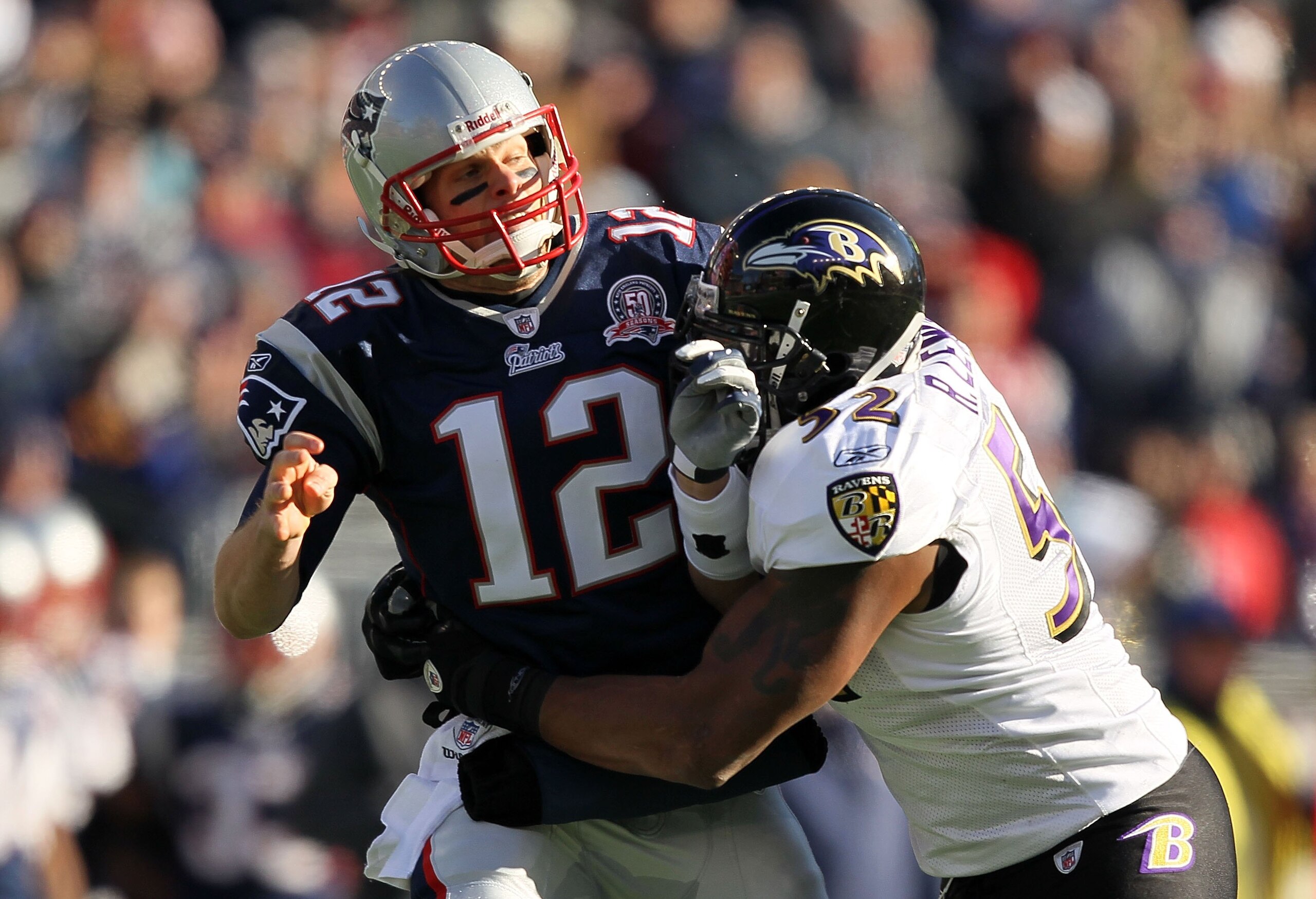 FOXBORO, MA - JANUARY 10:  Quarterback Tom Brady #12 of the New England Patriots is hit by Ray Lewis #52 of the Baltimore Ravens during the 2010 AFC wild-card playoff game at Gillette Stadium on January 10, 2010 in Foxboro, Massachusetts. The Ravens won 3