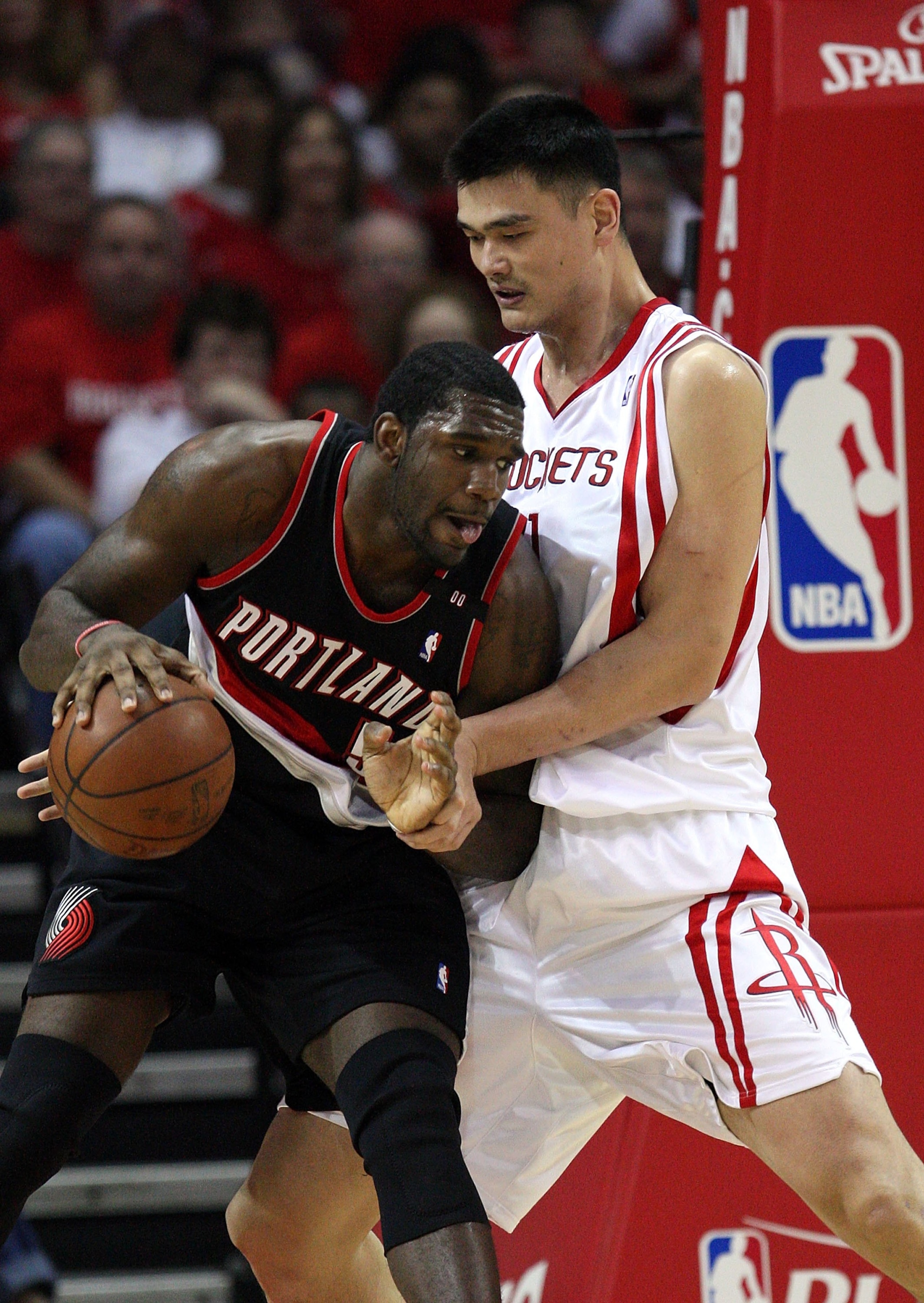 HOUSTON - APRIL 26:  Center Greg Oden #52 of the Portland Trail Blazers dribbles the ball against Yao Ming #11 of the Houston Rockets in Game Four of the Western Conference Quarterfinals during the 2009 NBA Playoffs at Toyota Center on April 26, 2009 in H