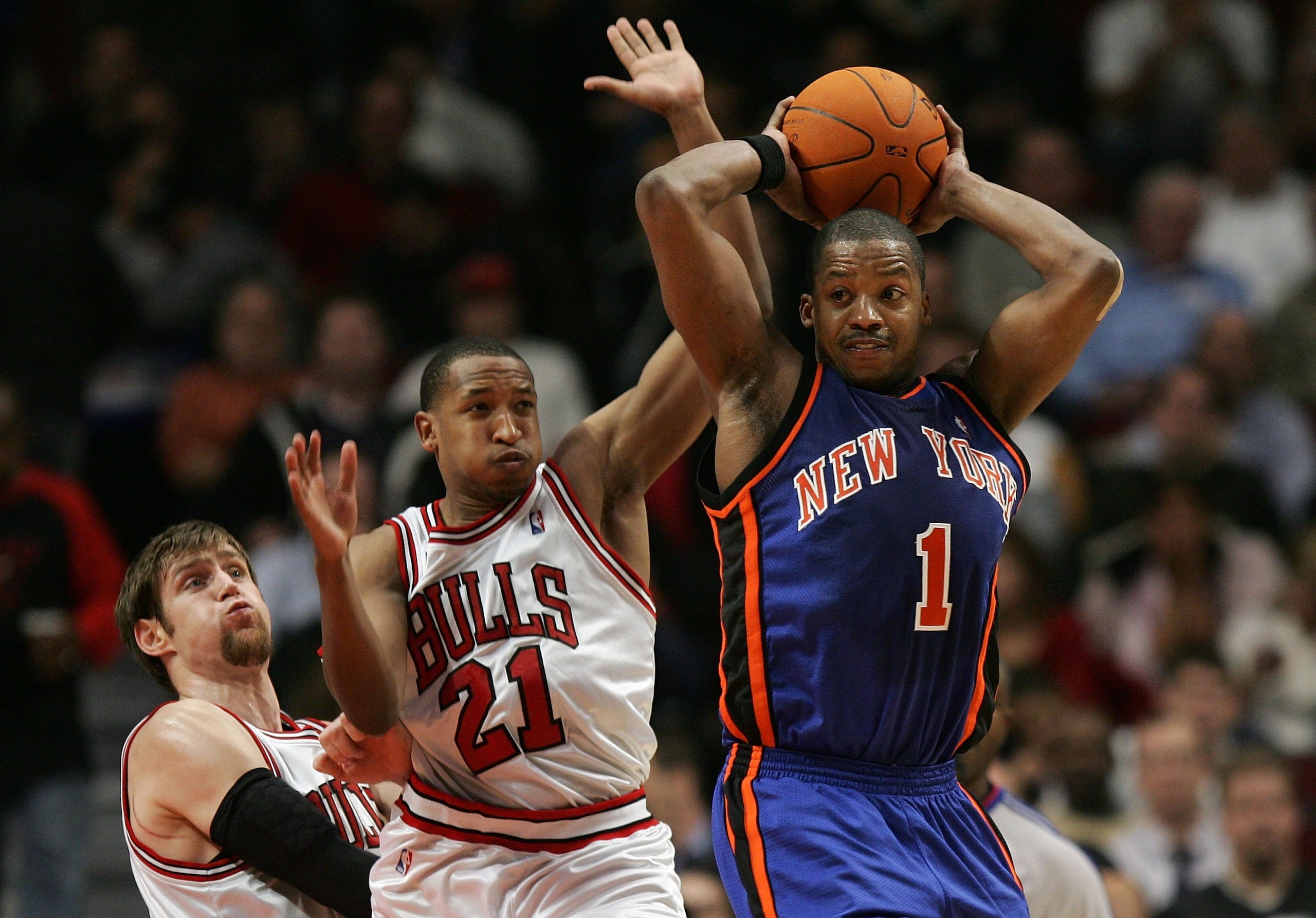 CHICAGO - NOVEMBER 28:  Steve Francis #1 of the New York Knicks looks to pass as he is defended by Chris Duhon #21 and Adres Nocioni #5 of the Chicago Bulls November 28, 2006 at the United Center in Chicago, Illinois.  NOTE TO USER: User expressly acknowl