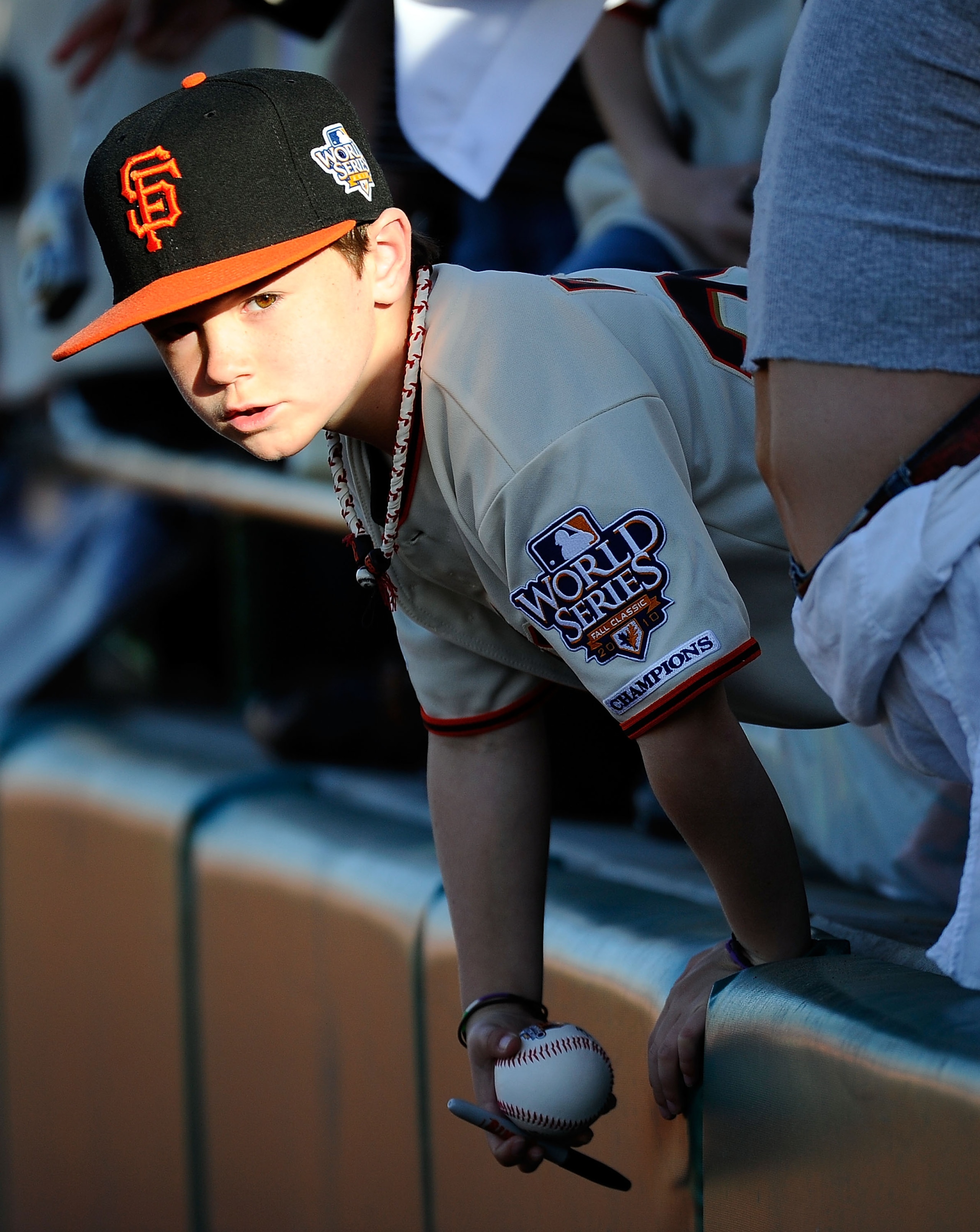 SCOTTSDALE, AZ - MARCH 07:  Seven year old Coleman Colucci, from Half Moon Bay, California, looks to get his ball signed by San Francisco Giants baseball players prior to the start of the spring training baseball game against the Texas Rangers at Scottsda