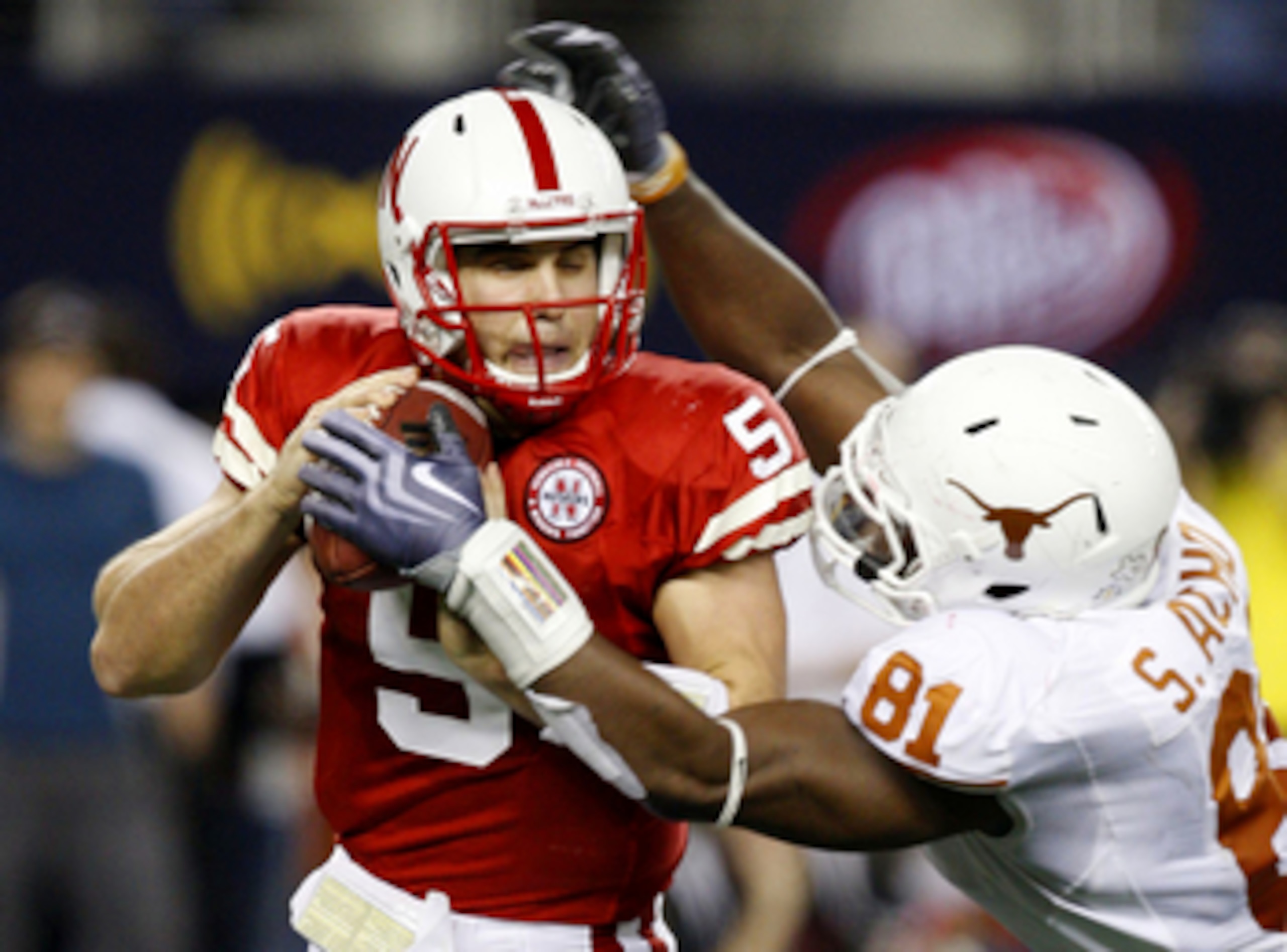 ARLINGTON, TX - DECEMBER 5: Quarterback Zac Lee of the Nebraska Cornhuskers is sacked by Sam Acho #81 of the Texas Longhorns at Cowboys Stadium on December 5, 2009 in Arlington, Texas.  (Photo by Ronald Martinez/Getty Images)