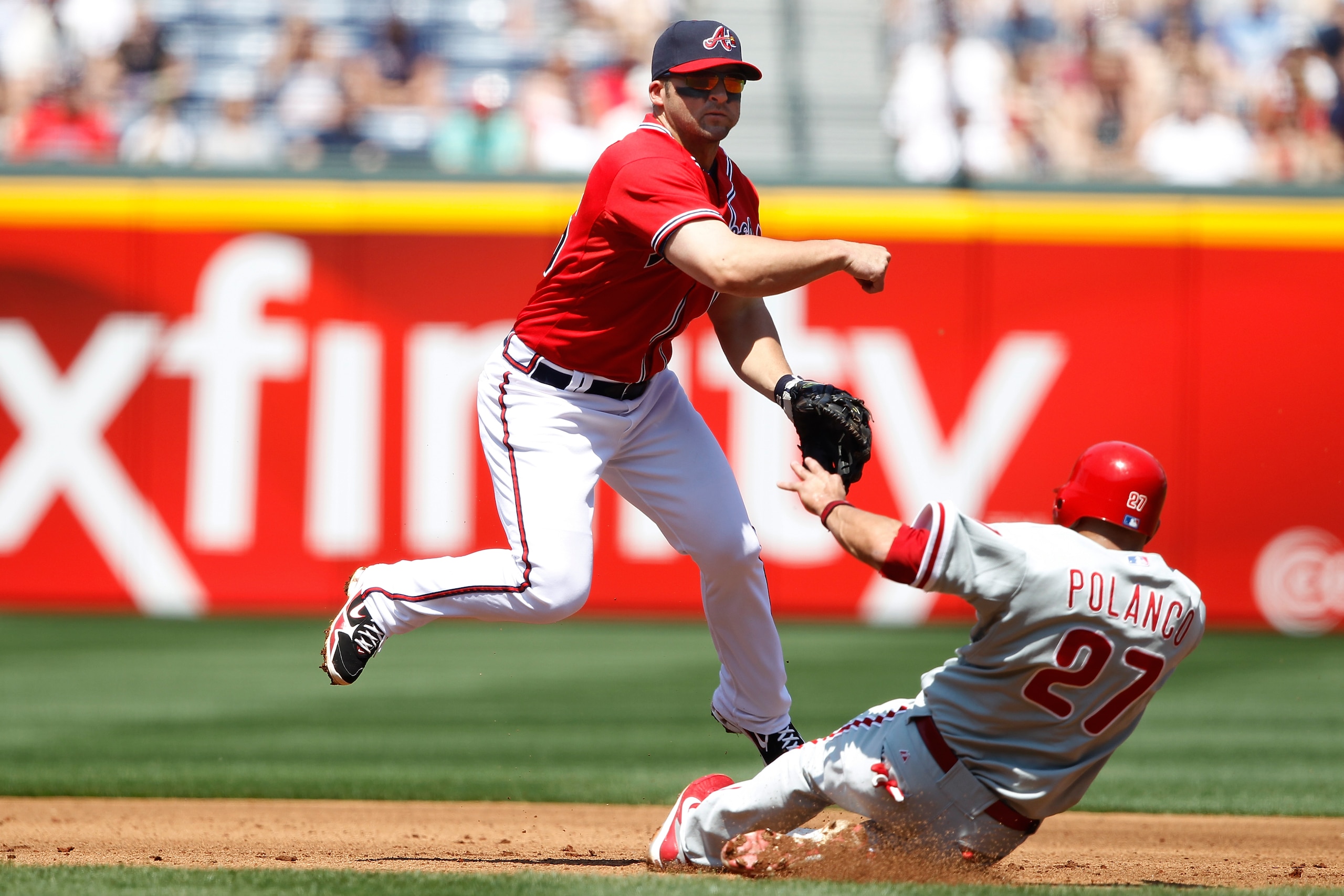 ATLANTA, GA - APRIL 10: Dan Uggla #26 of the Atlanta Braves throws to first to turn a double play over Placido Polanco #27 of the Philadelphia Phillies at Turner Field on April 10, 2011 in Atlanta, Georgia. The Phillies won 3-0. (Photo by Joe Robbins/Gett