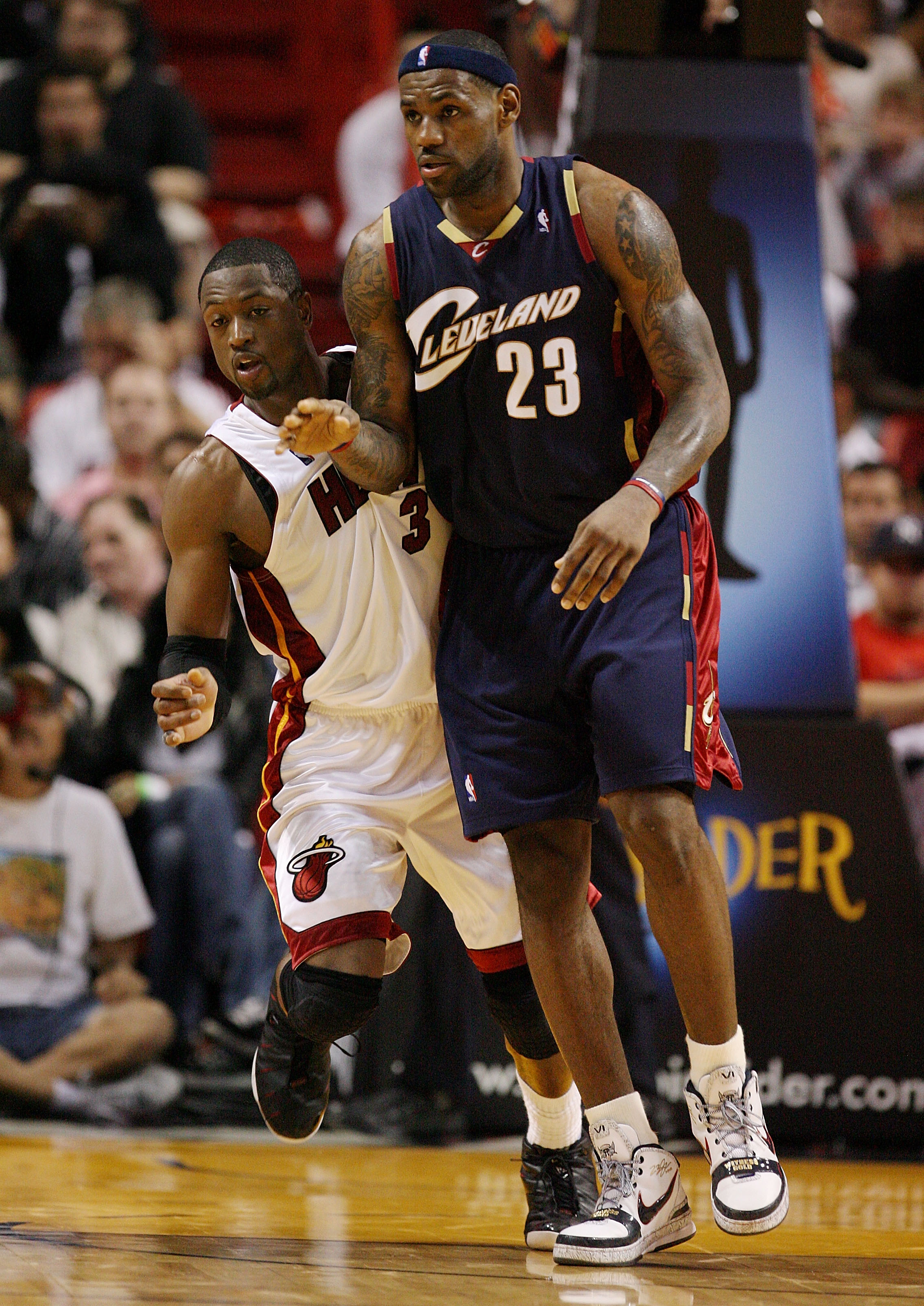 Miami Heat's Dwyane Wade, left, who scored 23 points, is guarded by New  Jersey Nets' Vince