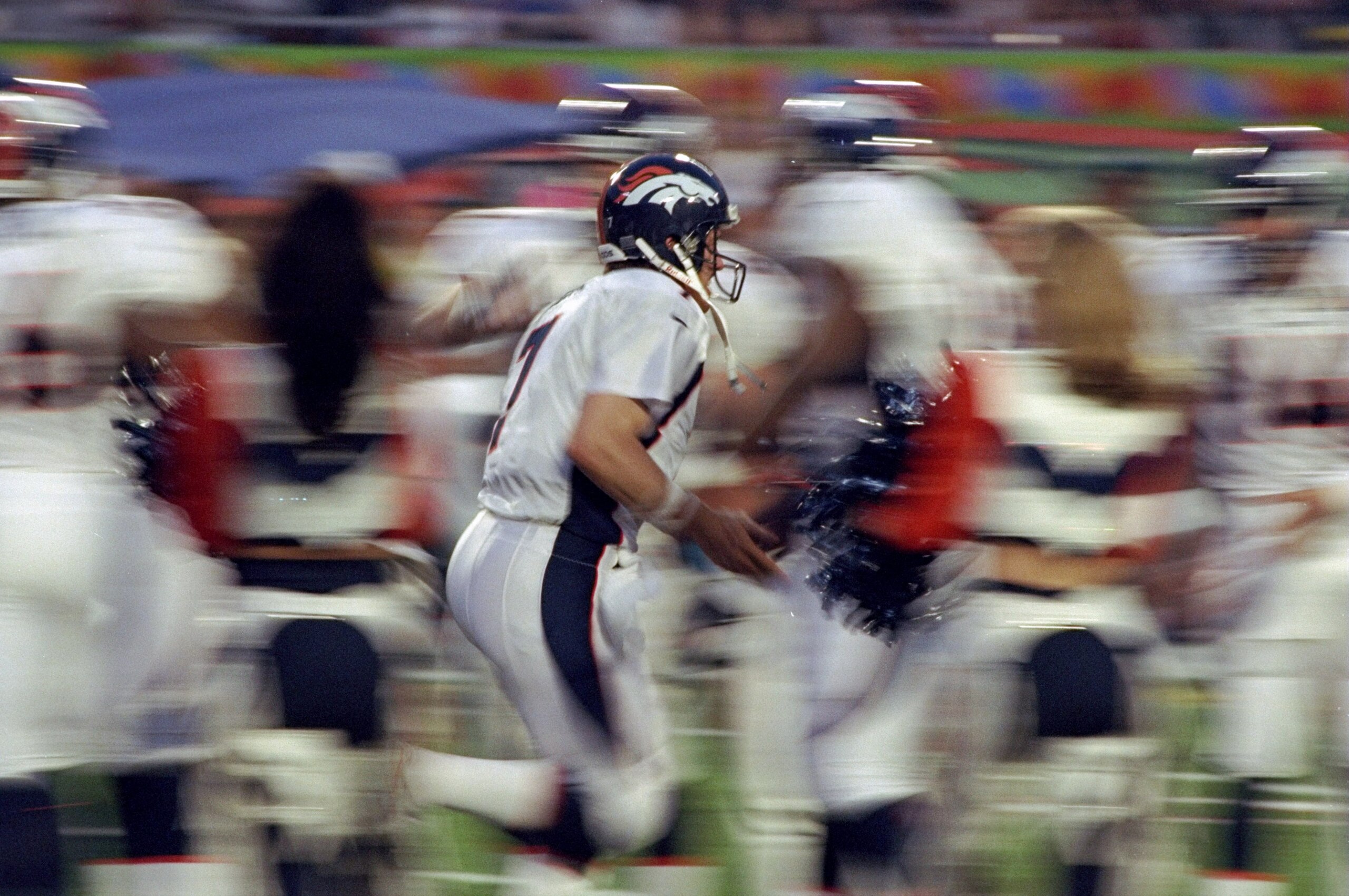 31 Jan 1999: Quarterback John Elway #7 of the Denver Broncos runs onto the field through the blur of his teammates during pre-game introductions for Super Bowl XXXIII between the Atlanta Falcons and the Denver Broncos at Pro Player Stadium in Miami, Flori