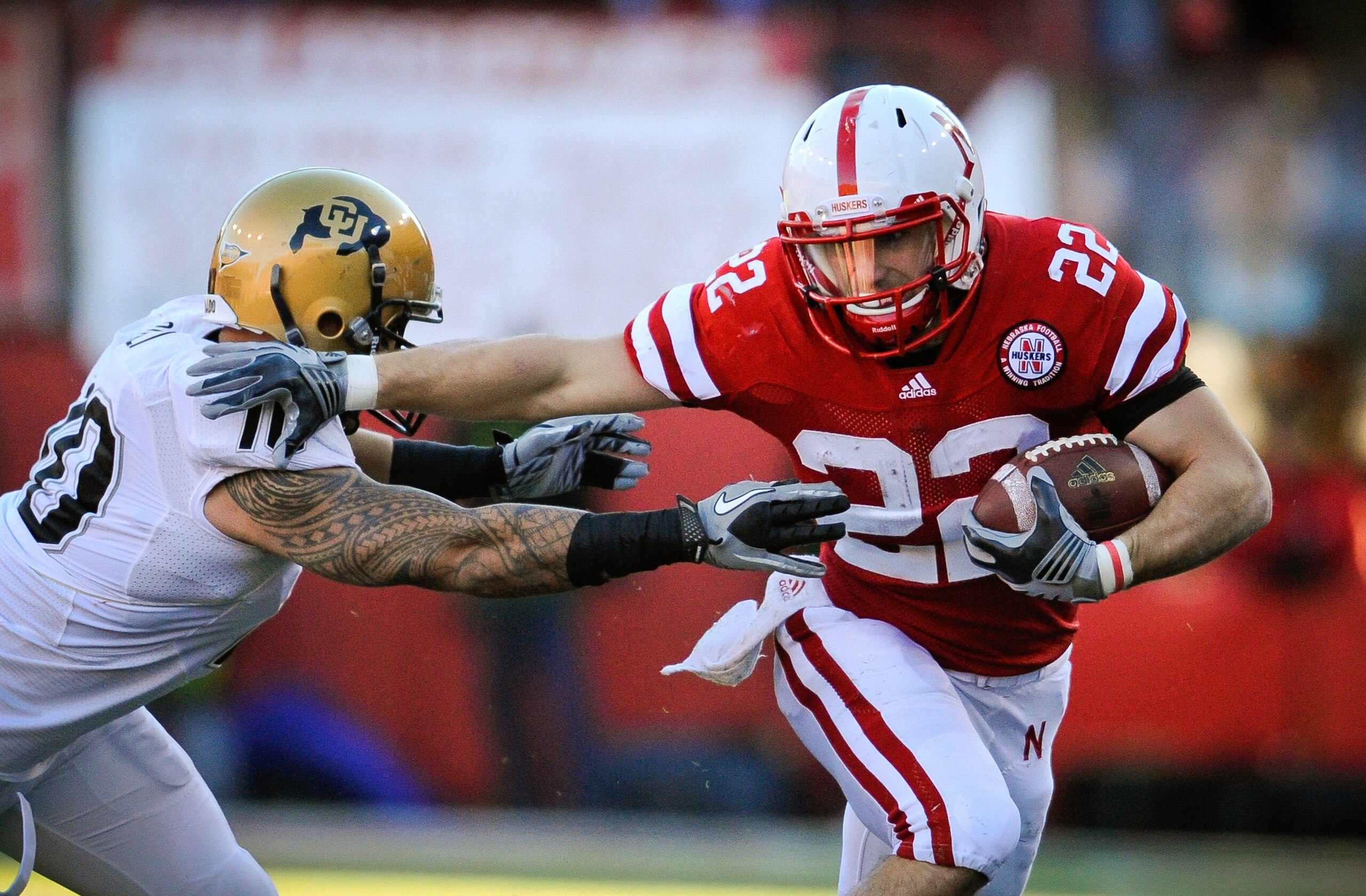 LINCOLN, NE - NOVEMBER 26: Rex Burkhead #22 of the Nebraska Cornhuskers runs past Michael Sipili #10 of the Colorado Buffaloes during the first half of their game at Memorial Stadium on November 26, 2010 in Lincoln, Nebraska. (Photo by Eric Francis/Getty LINCOLN, NE - NOVEMBER 26: Rex Burkhead #22 of the Nebraska Cornhuskers runs past Michael Sipili #10 of the Colorado Buffaloes during the first half of their game at Memorial Stadium on November 26, 2010 in Lincoln, Nebraska. (Photo by Eric Francis/Getty