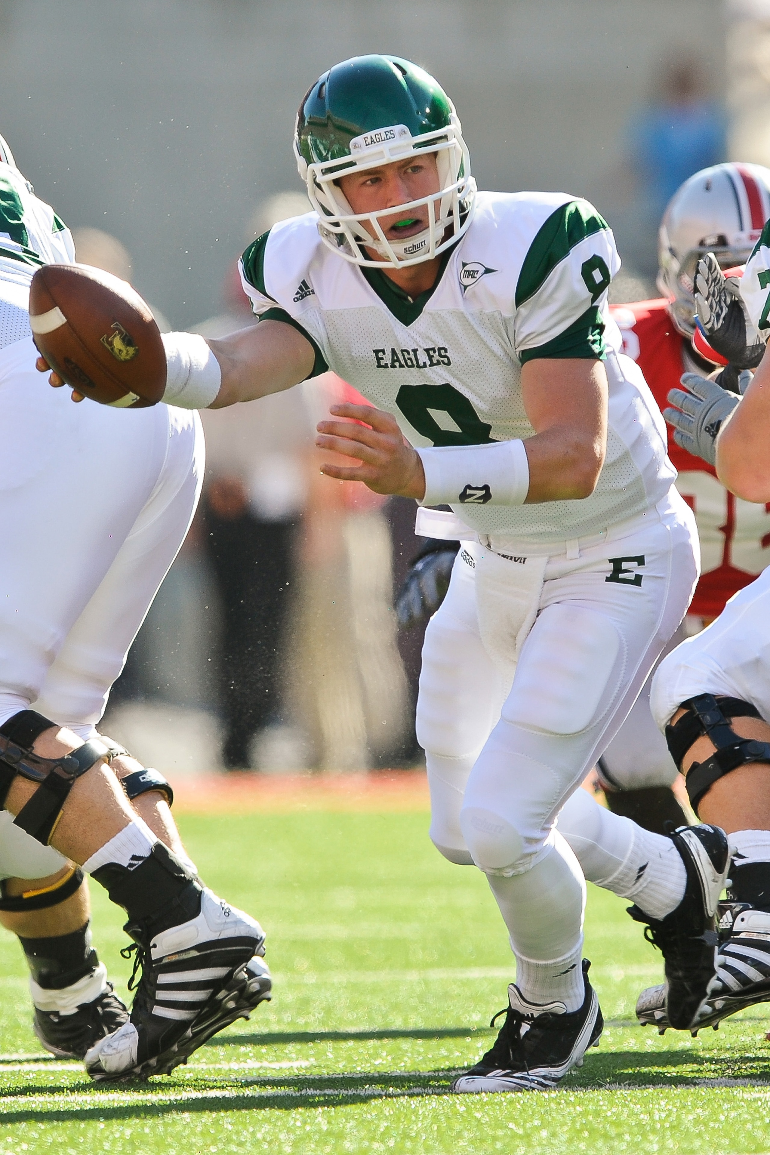 COLUMBUS, OH - SEPTEMBER 25:  Quarterback Alex Gillett #8 of the Eastern Michigan Eagles hands off the ball against the Ohio State Buckeyes at Ohio Stadium on September 25, 2010 in Columbus, Ohio.  Ohio State won 73-20. (Photo by Jamie Sabau/Getty Images)