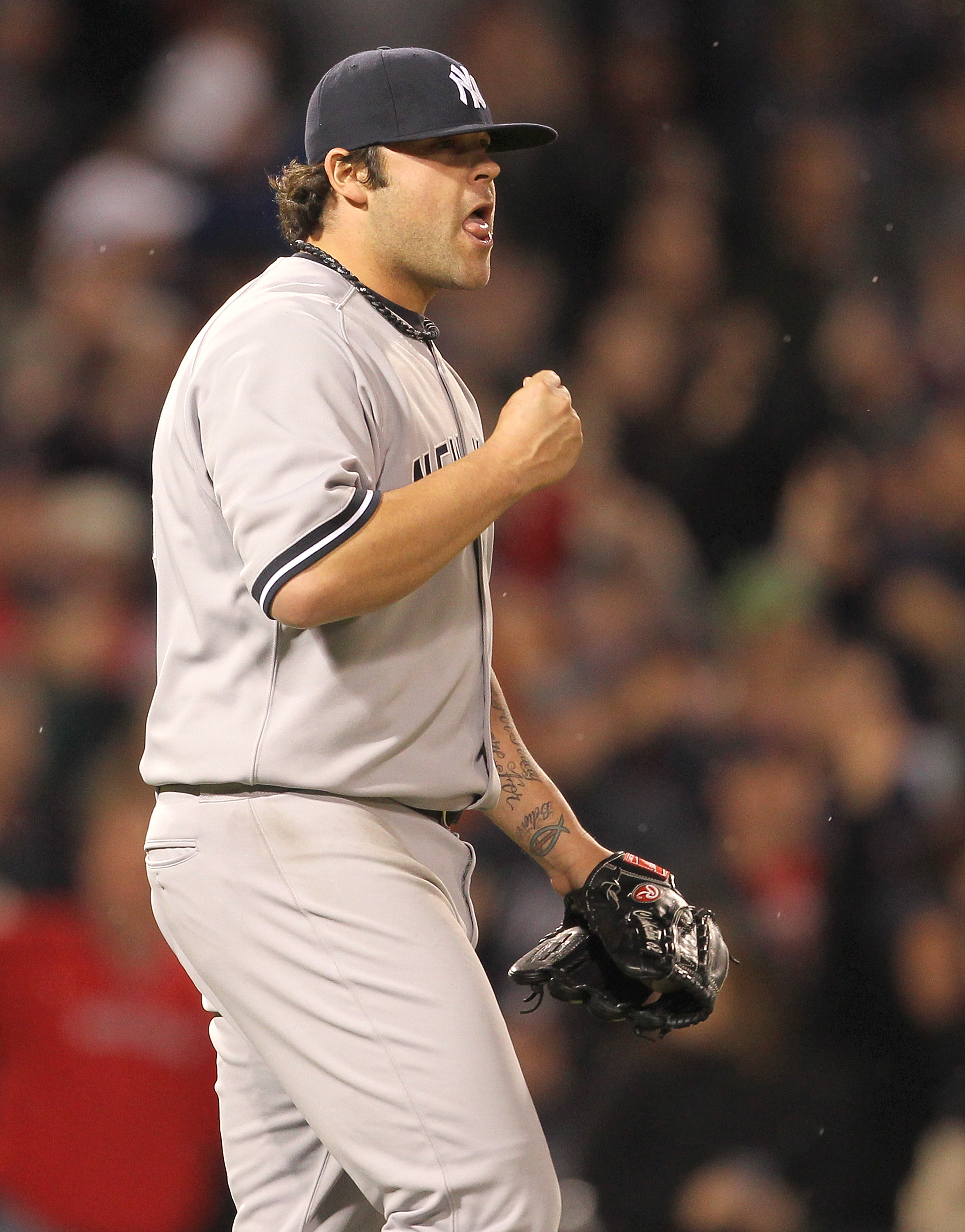 BOSTON, MA - APRIL 10:  Joba Chamberlain #62 of the New York Yankees reacts after giving up two runs against the Boston Red Sox at Fenway Park April 10, 2011 in Boston, Massachusetts. (Photo by Jim Rogash/Getty Images)