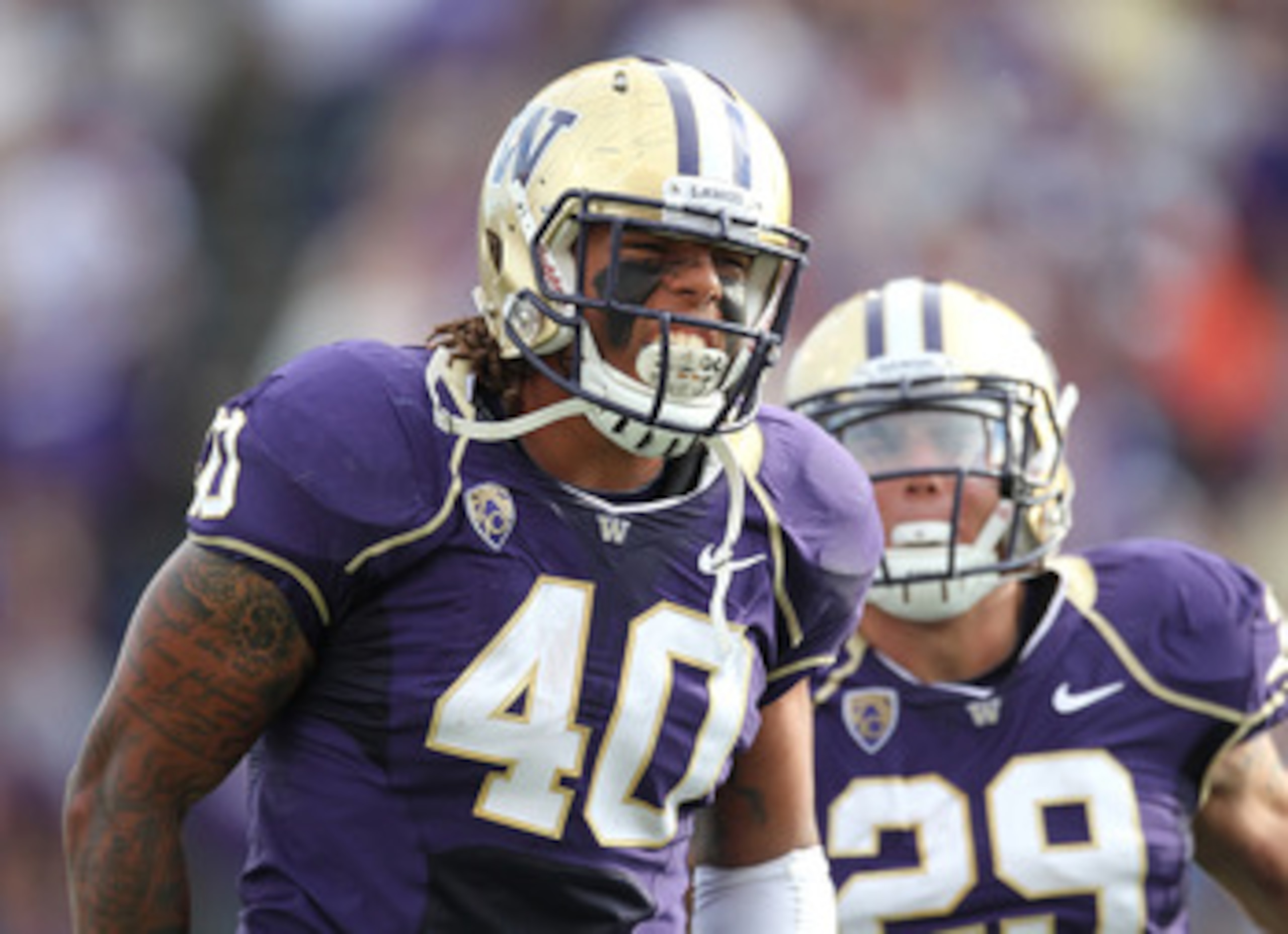 SEATTLE - SEPTEMBER 11: Linebacker Mason Foster #40 of the Washington Huskies celebrates with Willis Wilson #29 after tackling quarterback Ryan Nassib #12 of the Syracuse Orange and causing a fumble on September 11, 2010 at Husky Stadium in Seattle, Wash SEATTLE - SEPTEMBER 11: Linebacker Mason Foster #40 of the Washington Huskies celebrates with Willis Wilson #29 after tackling quarterback Ryan Nassib #12 of the Syracuse Orange and causing a fumble on September 11, 2010 at Husky Stadium in Seattle, Wash