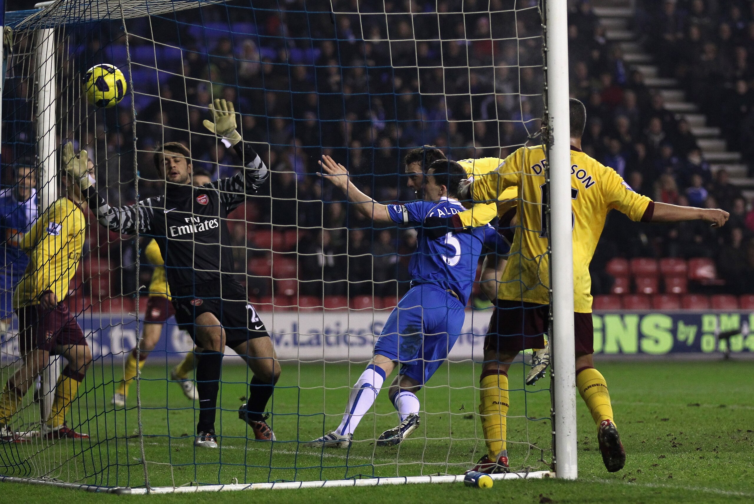WIGAN, ENGLAND - DECEMBER 29:  Sebastien Squillaci of Arsenal scores an own goal to level the scores during the Barclays Premier League match between Wigan Athletic and Arsenal at DW Stadium on December 29, 2010 in Wigan, England.  (Photo by Alex Livesey/